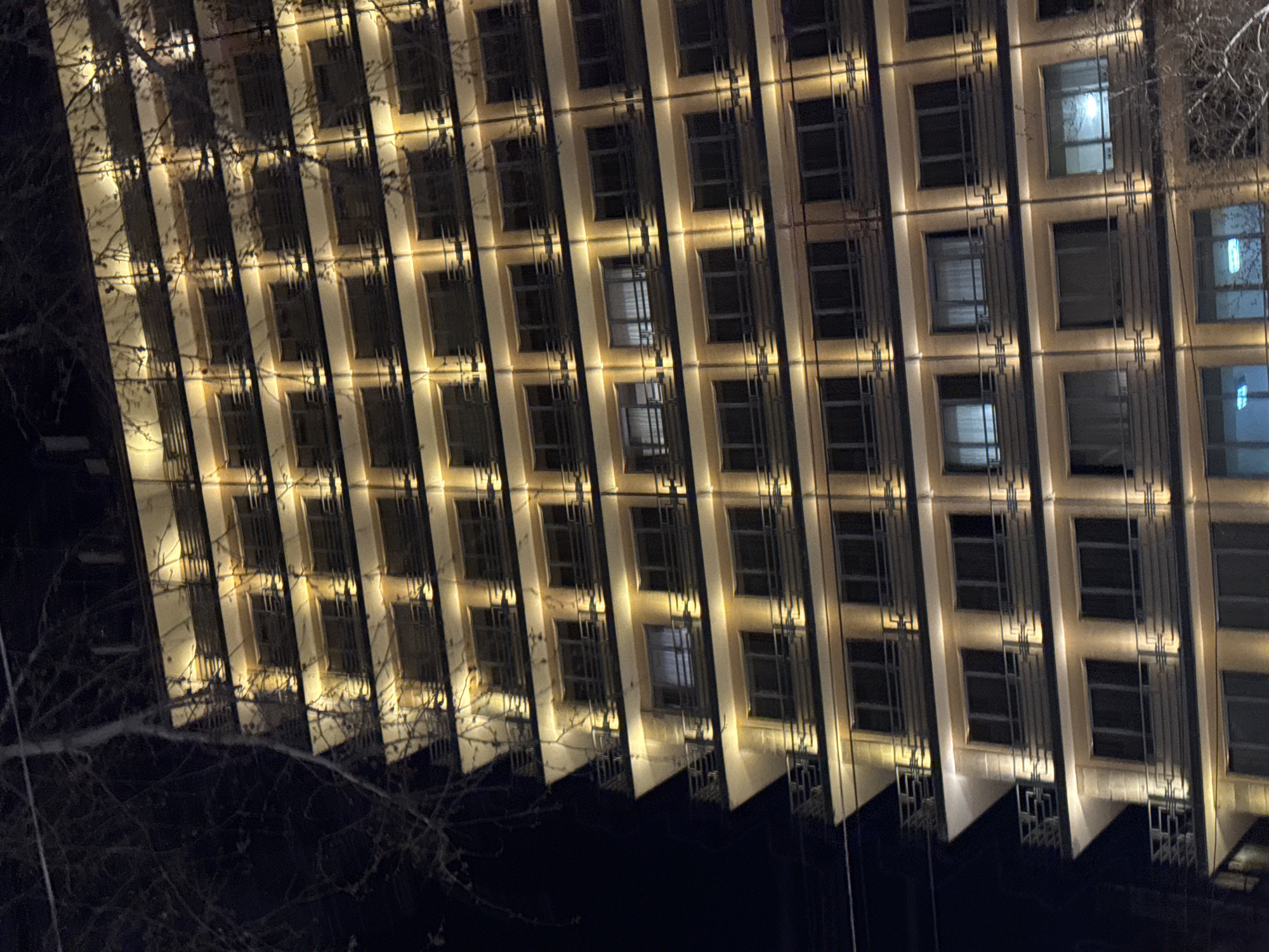 Illuminated Coca-Cola sign cycles colors on Yerevan building