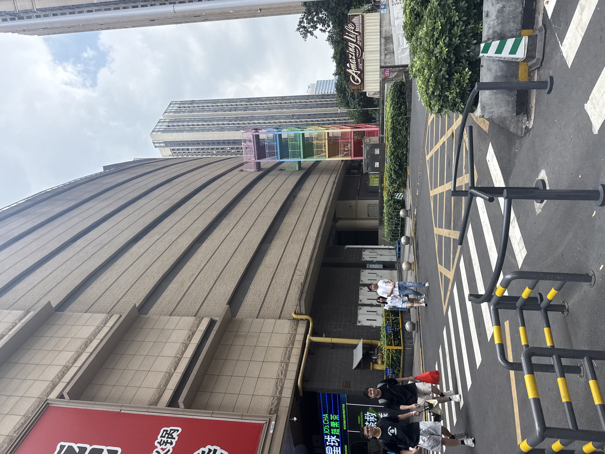 Haizhu District streets buzzing with delivery activity and parked scooters