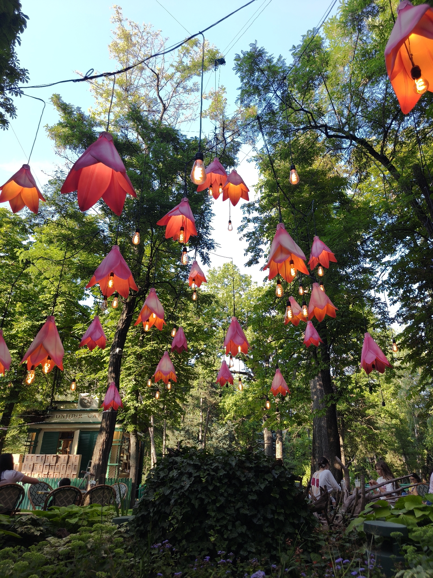 Bonjour Café's charming outdoor garden setup with decorative lanterns
