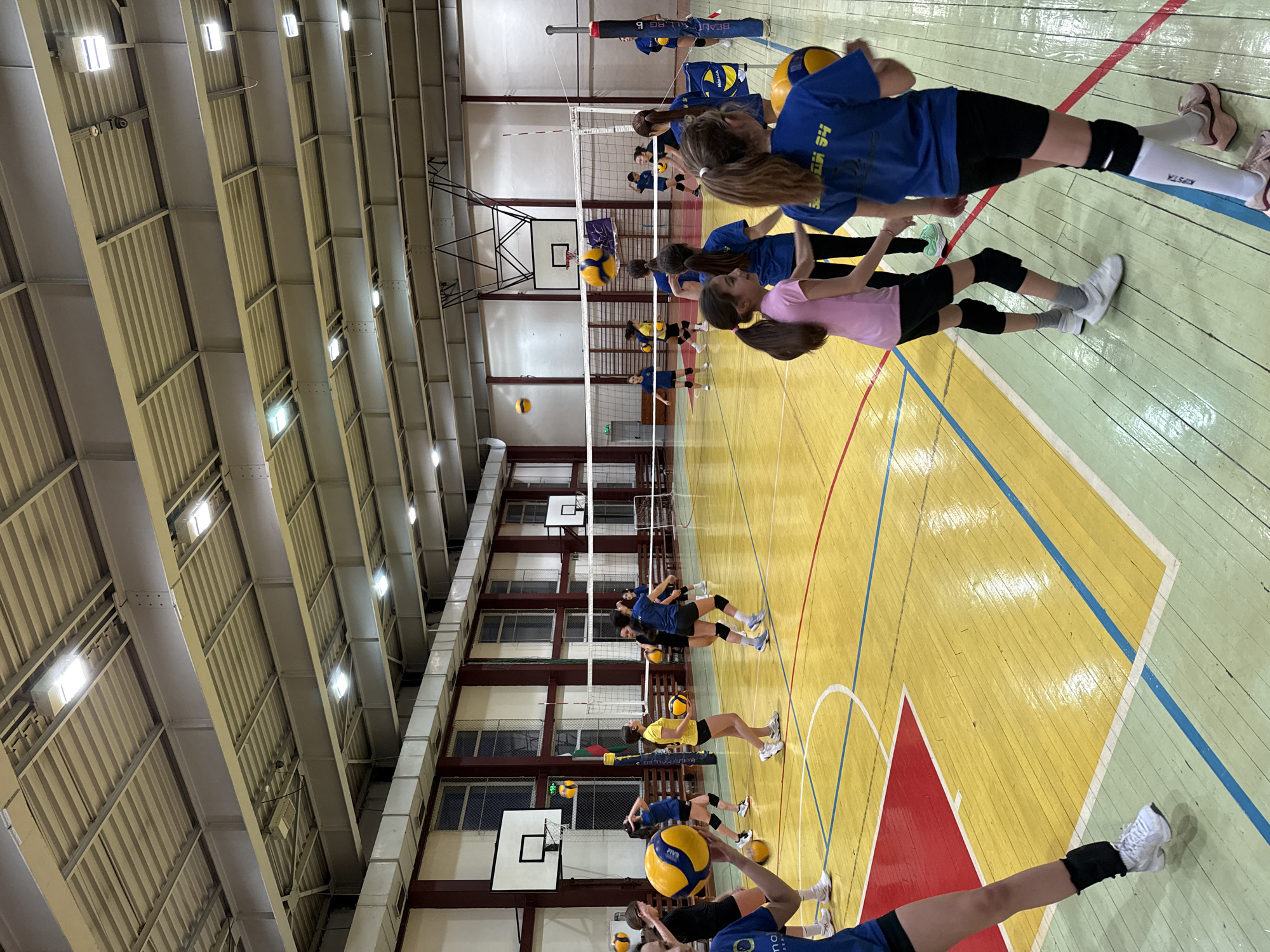 Volleyball practice session documented in Sofia gymnasium