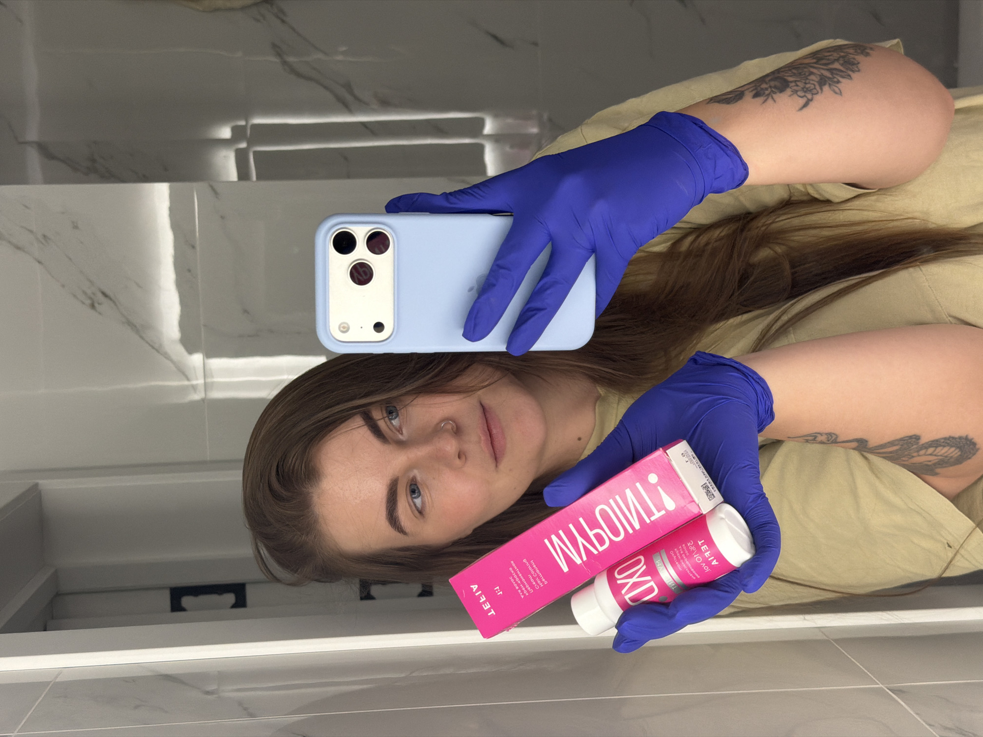 Person documents hair dyeing session in Russian bathroom selfies
