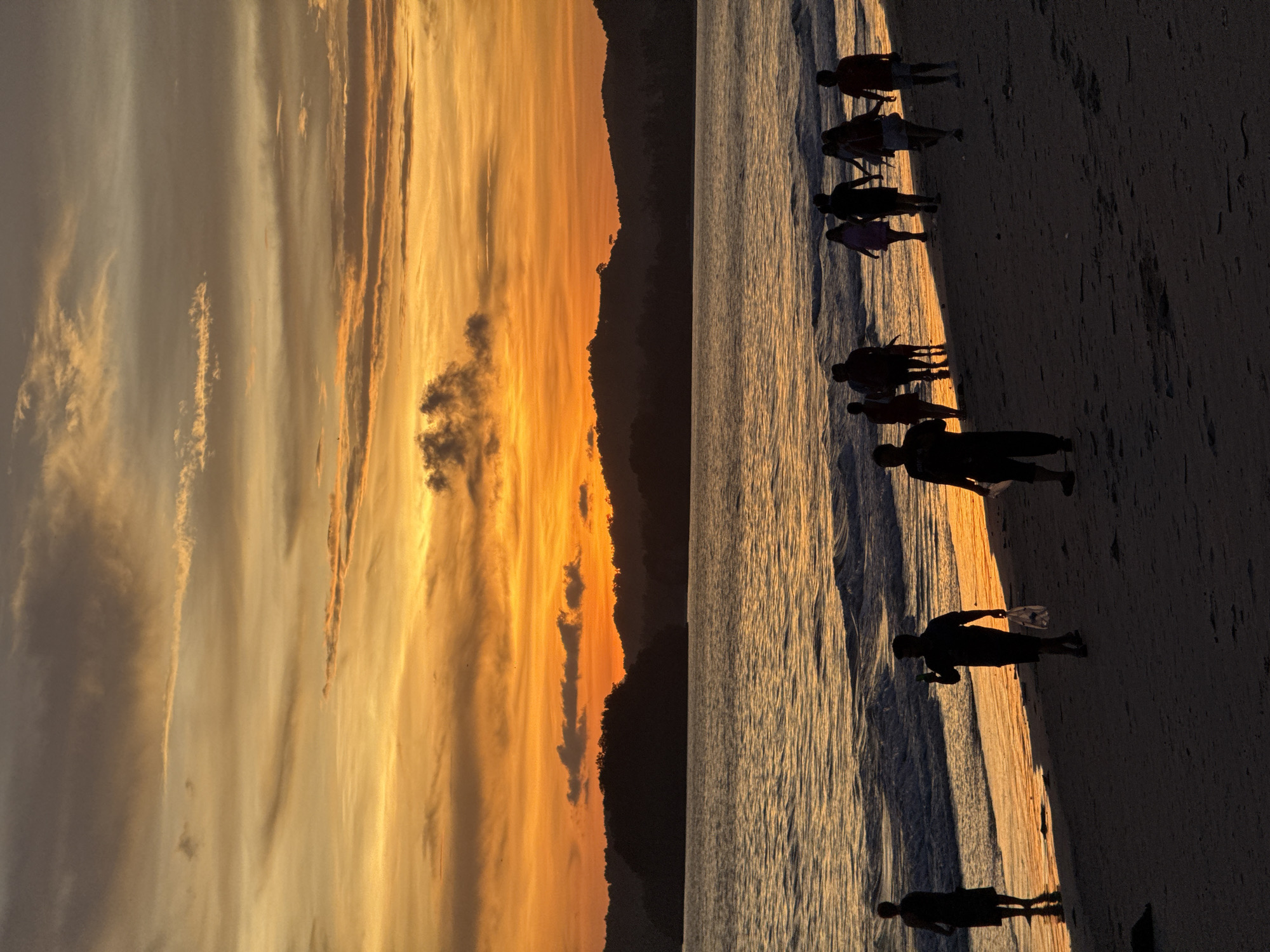 Sunset beach gathering with fireworks in Thailand