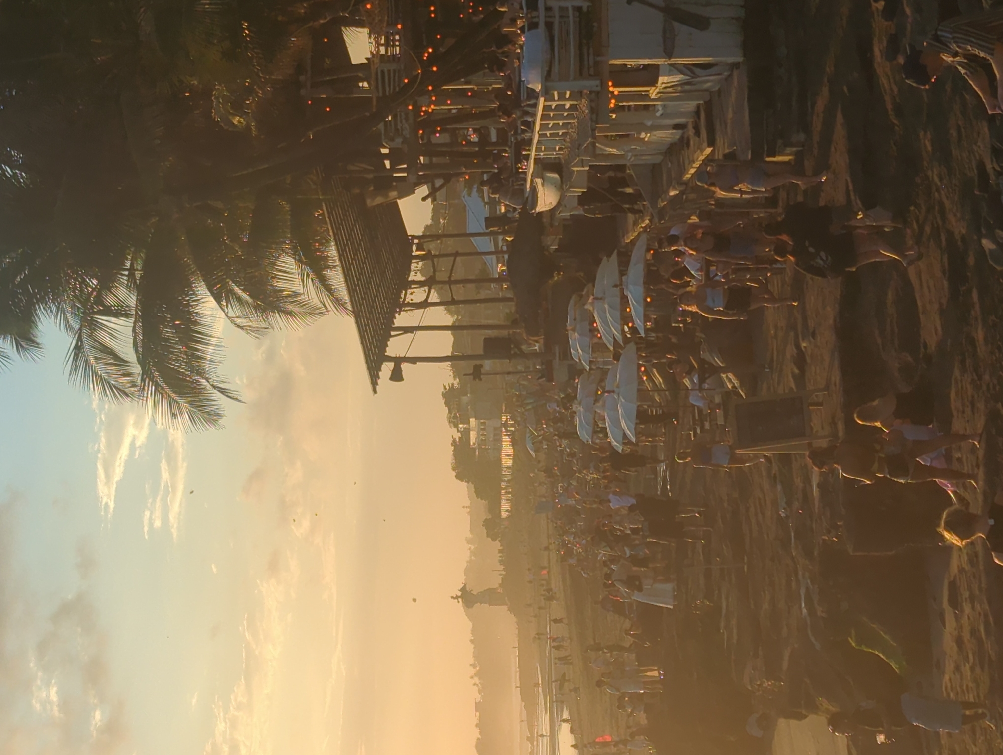 Musician performs acoustic set during crowded North Kuta sunset