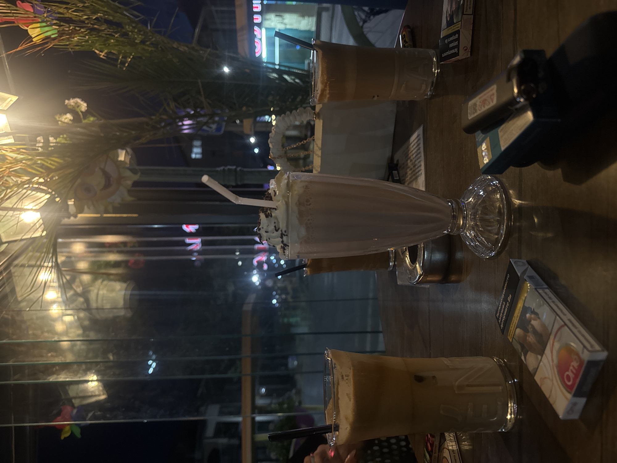 Outdoor cafe table setting with beverages observed