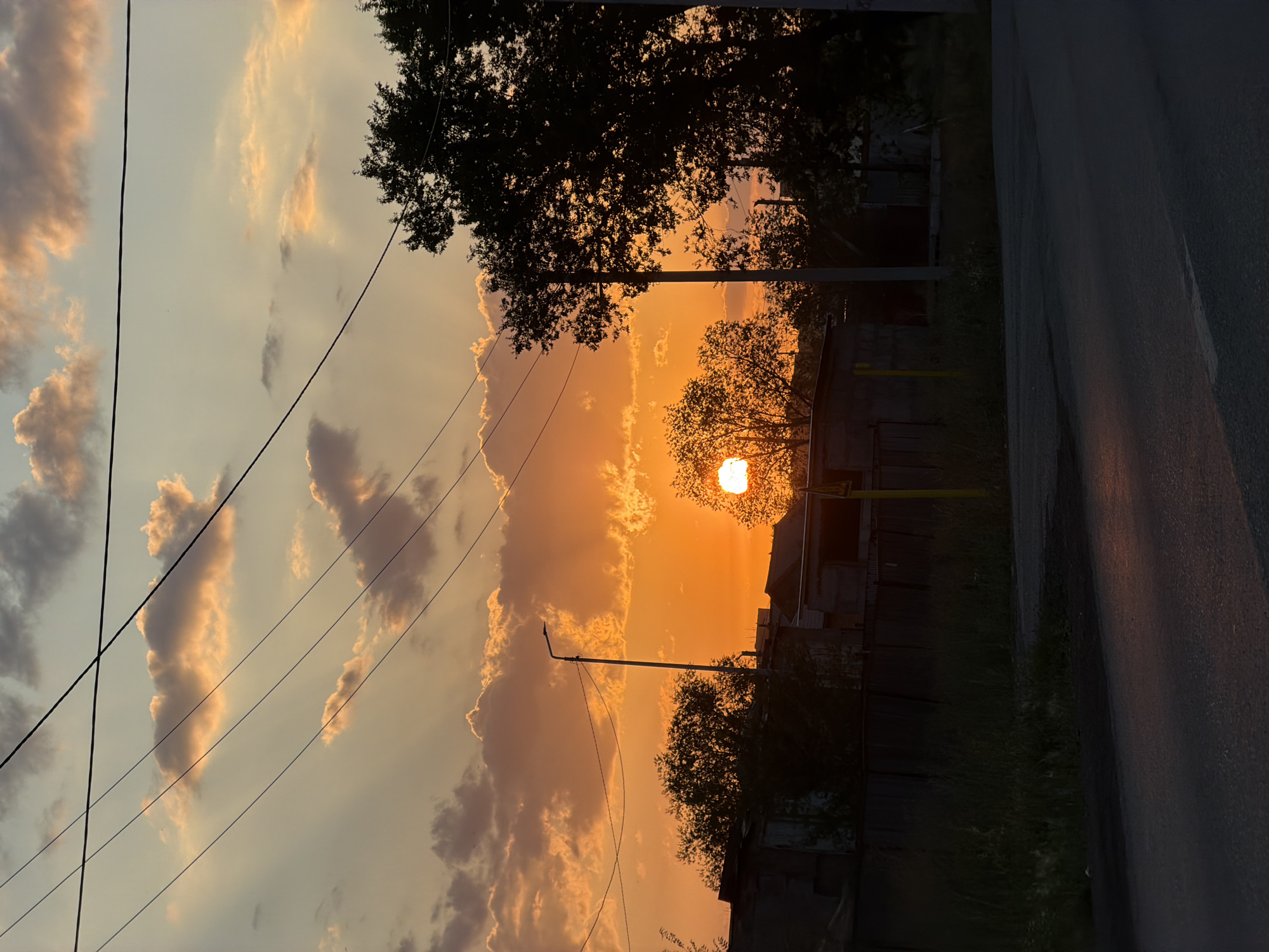 Vivid orange sunset silhouettes Temirtau's skyline infrastructure