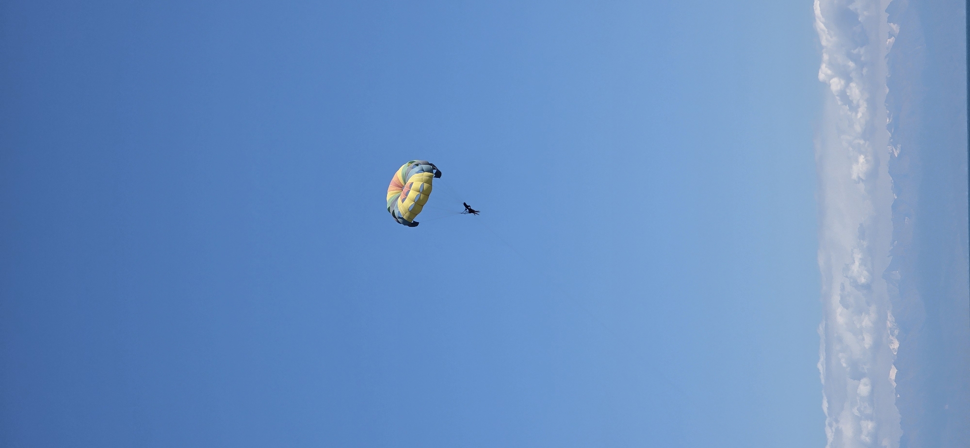 Summer day at a Kyrgyz lakeside beach with parasailing
