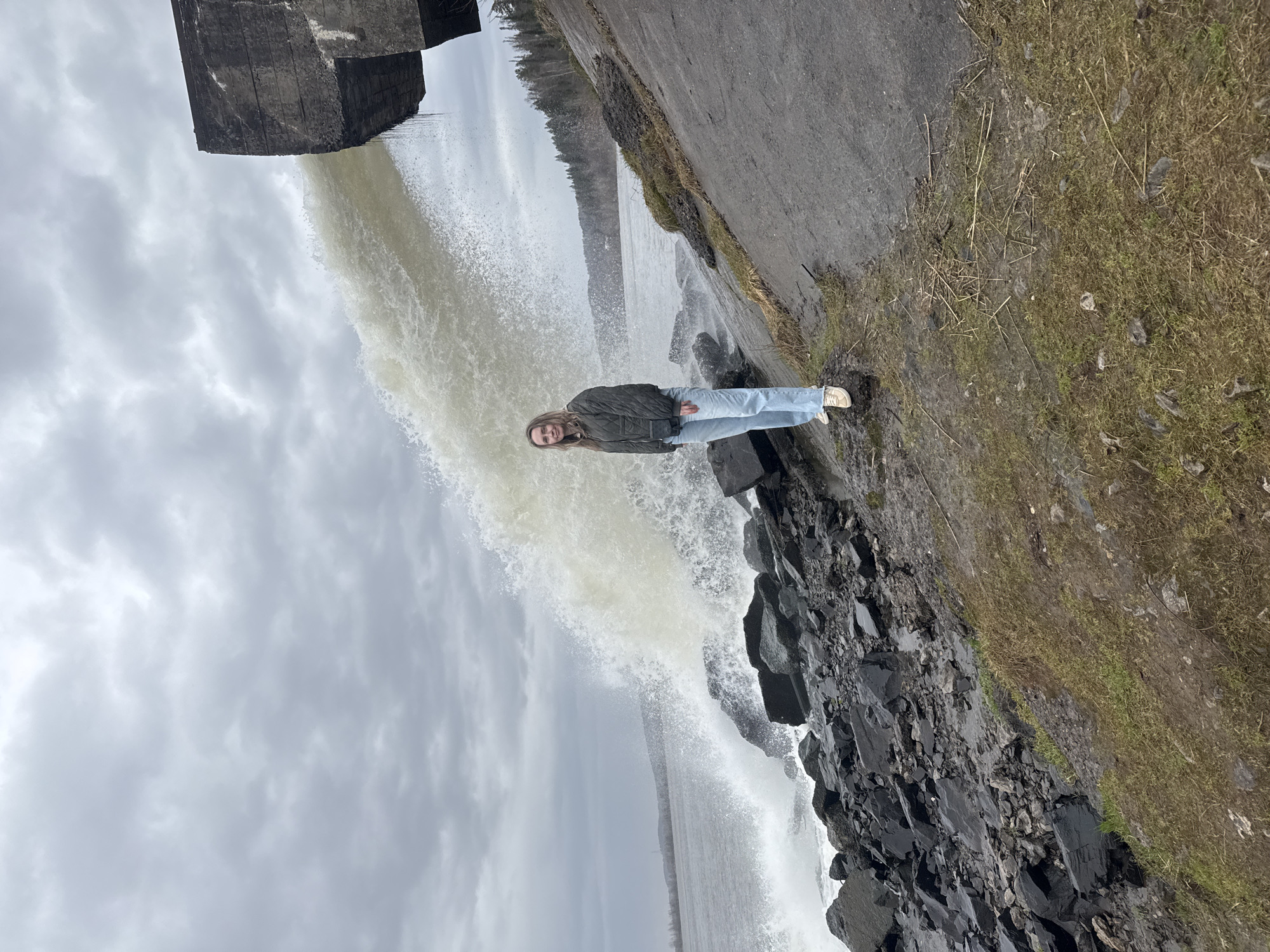 Woman poses by waterfall in Chernushka, Russia