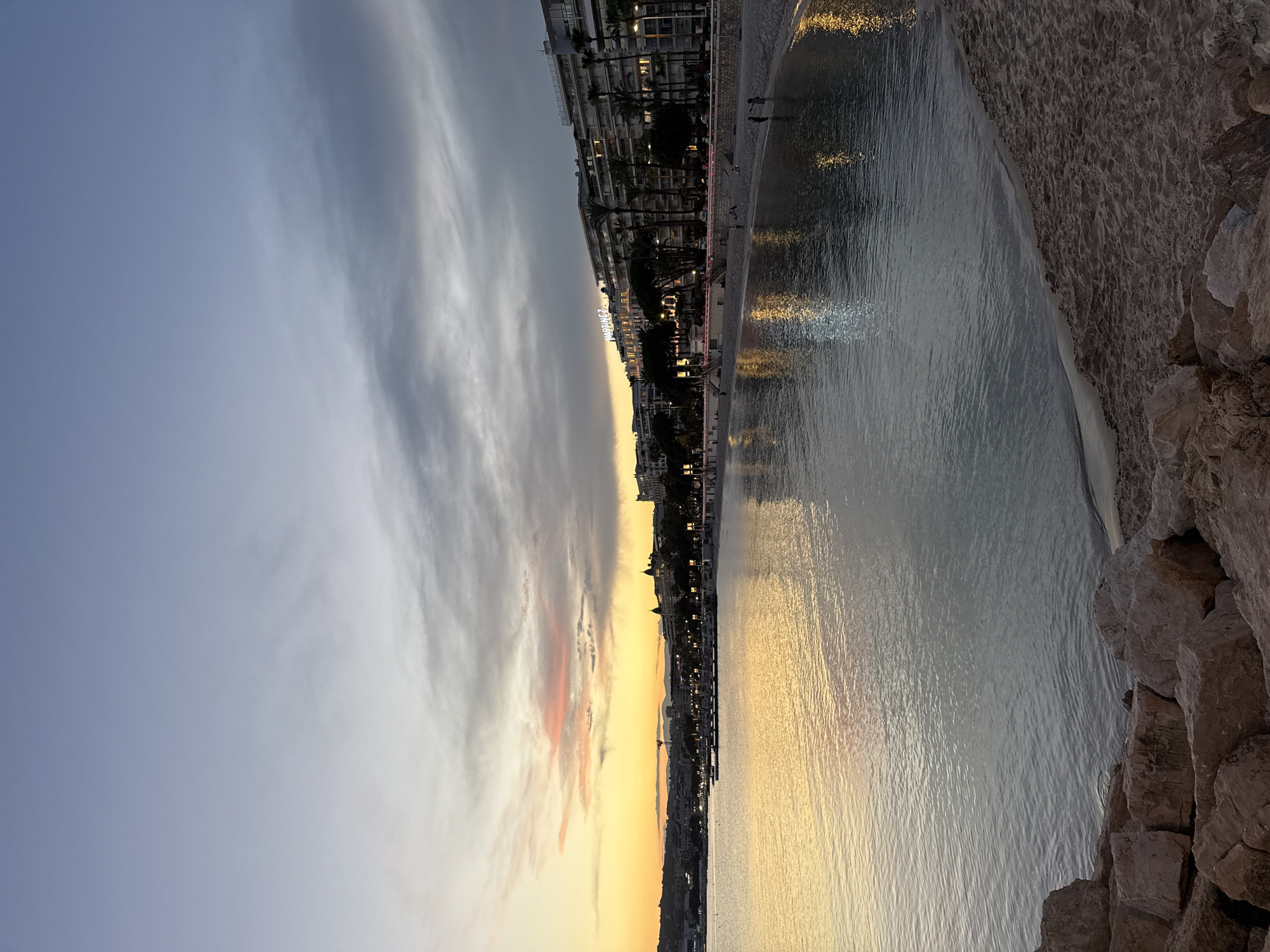Cannes waterfront at dusk, from beach bars to marina