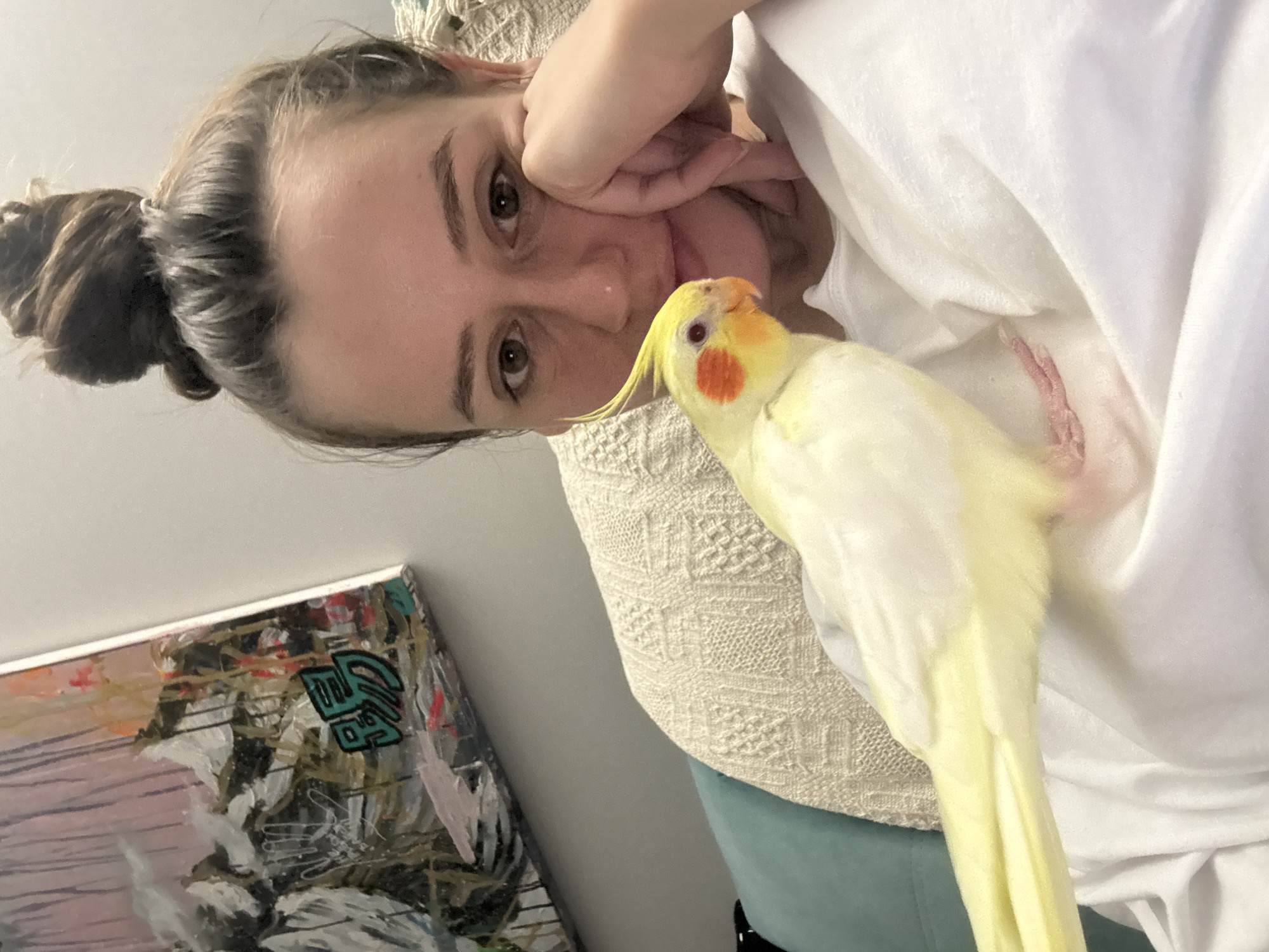 Woman poses with pet cockatiel in Krasnoyarsk home