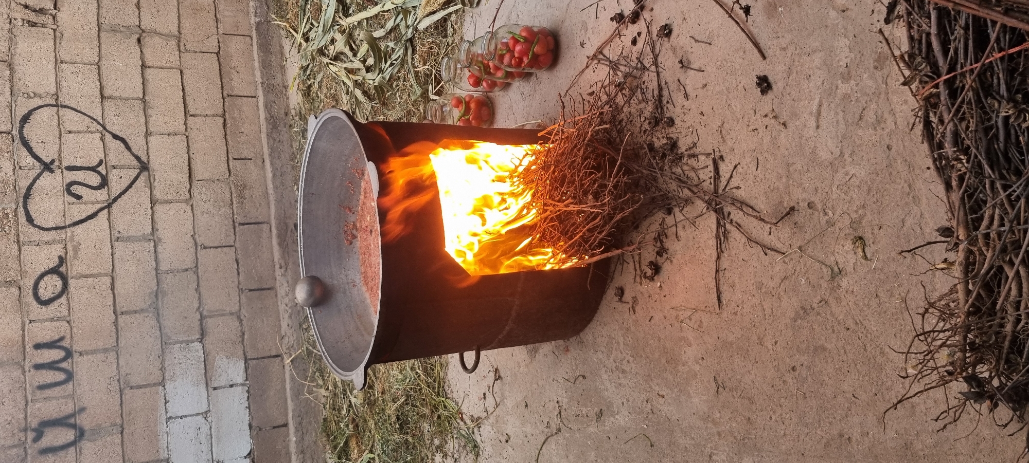 Tomato preserves cooking over open fire in Ҷомӣ, Tajikistan