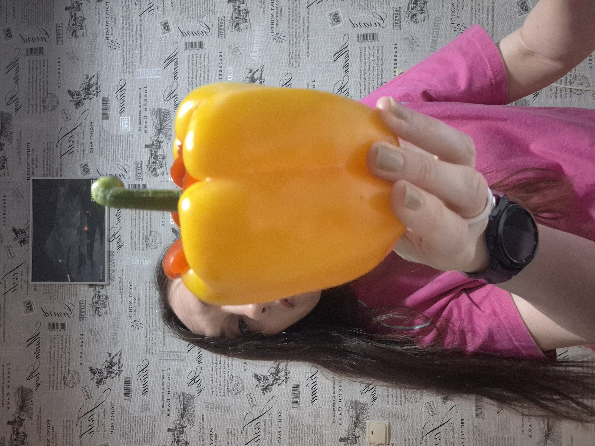 Person Creates Whimsical Bell Pepper Sculptures, Poses Playfully
