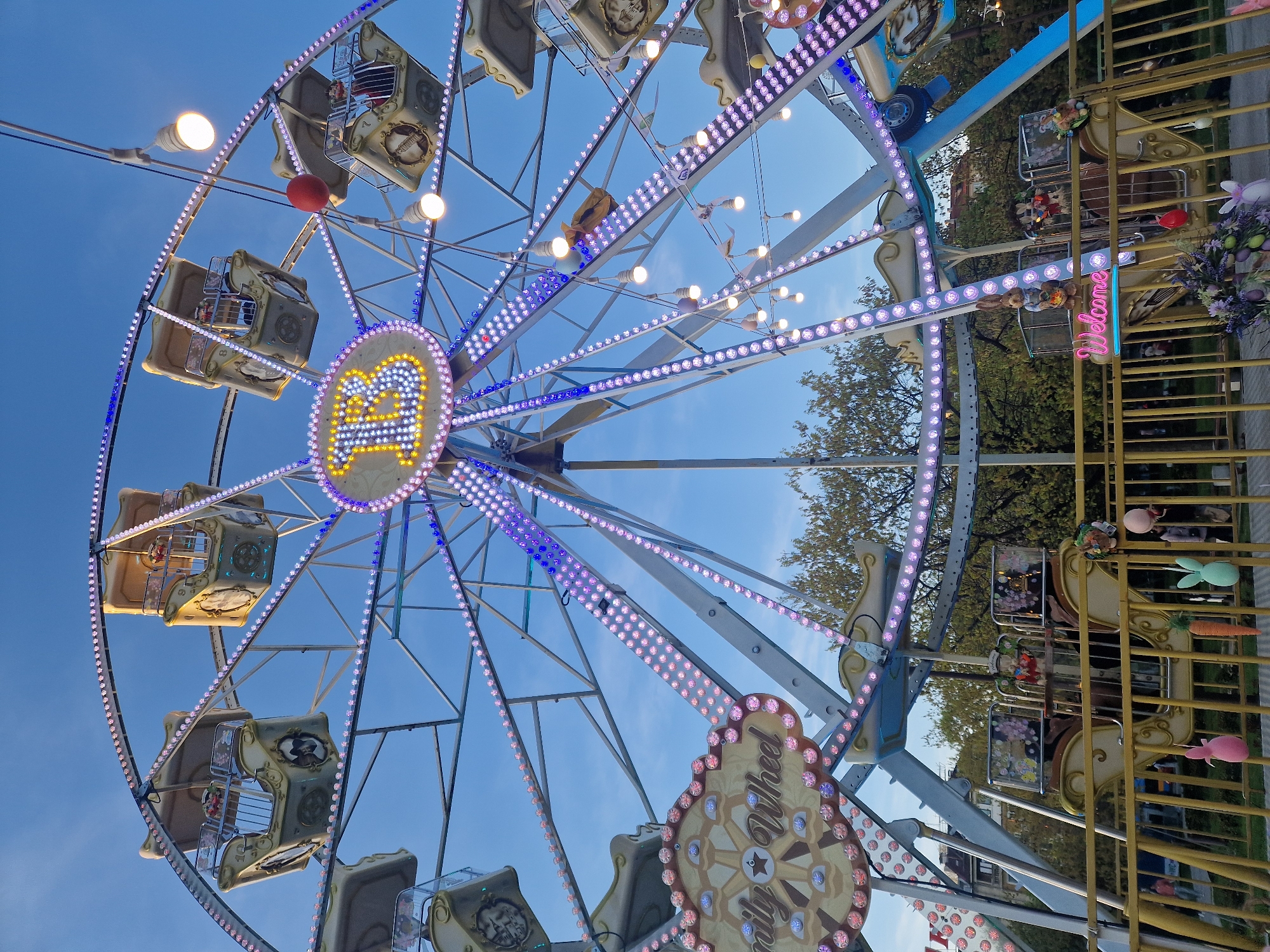 Evening carnival draws crowds to public square during golden hour