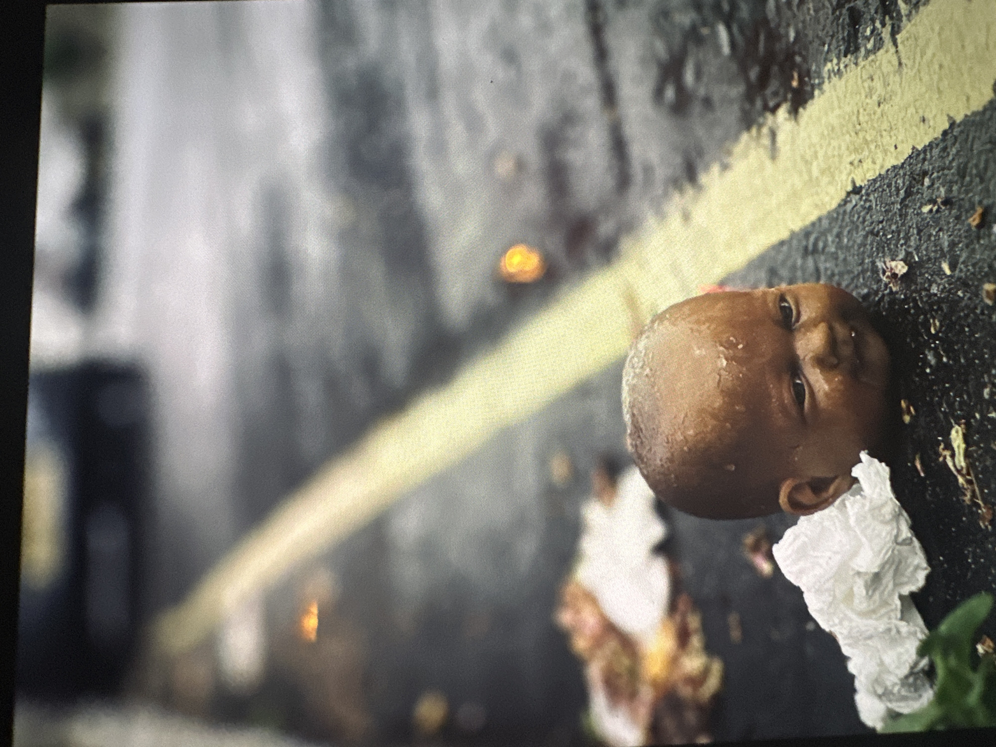London evening scenes: discarded doll, man at table