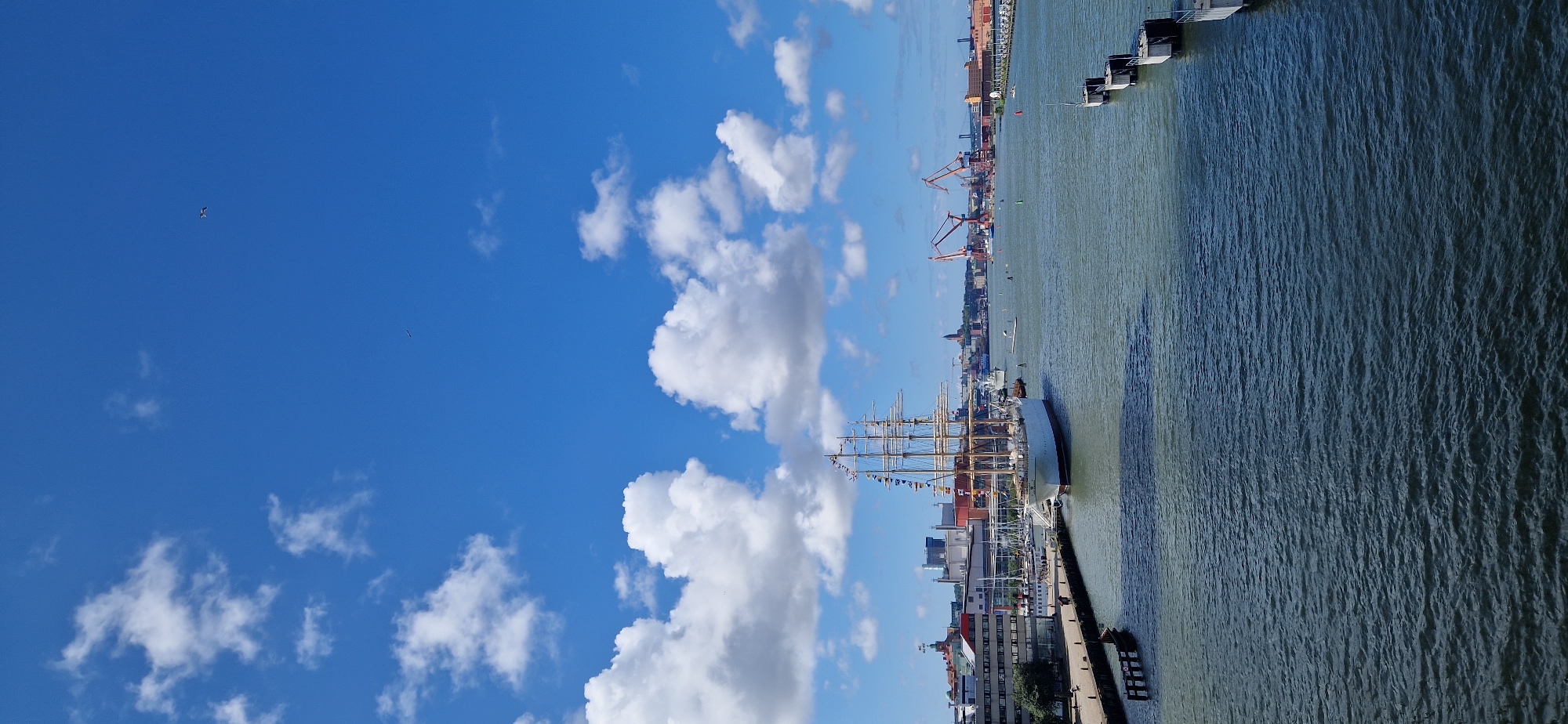 Crowd gathers at Gothenburg waterfront on a sunny summer morning