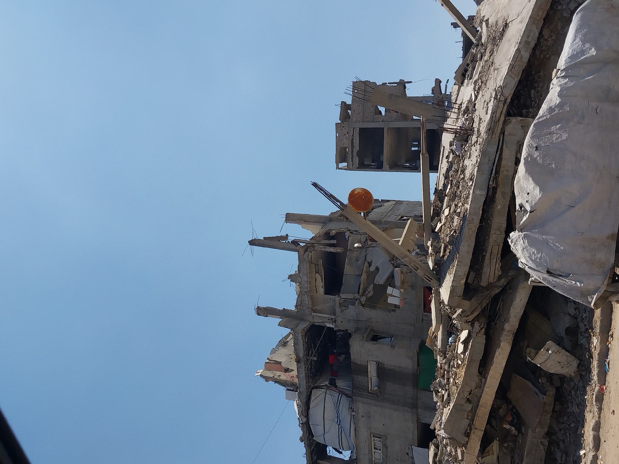 Damaged building with exposed rebar documented in Gaza