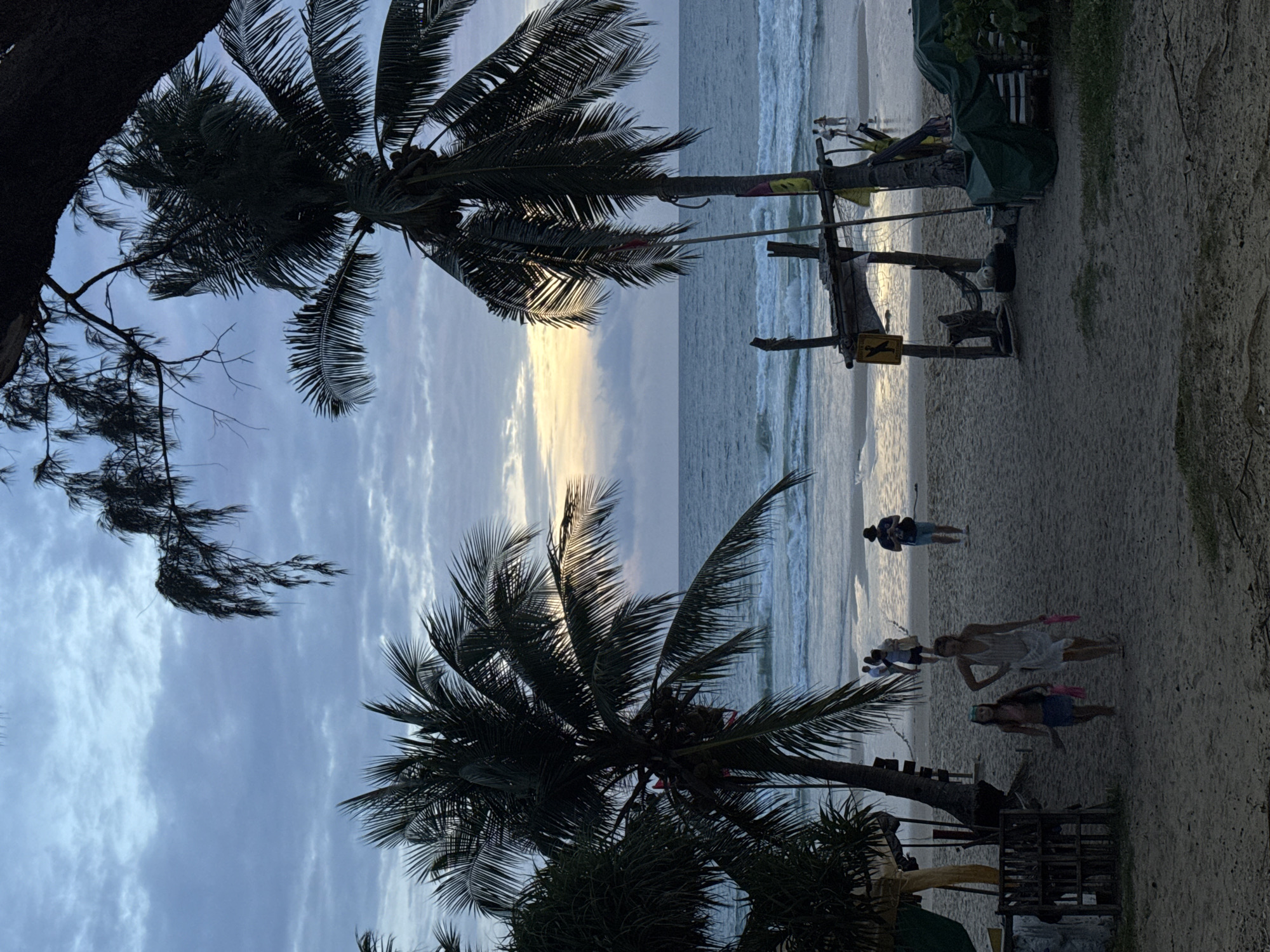 Karon Beach at dusk: shoreline calm, streets quietly moving