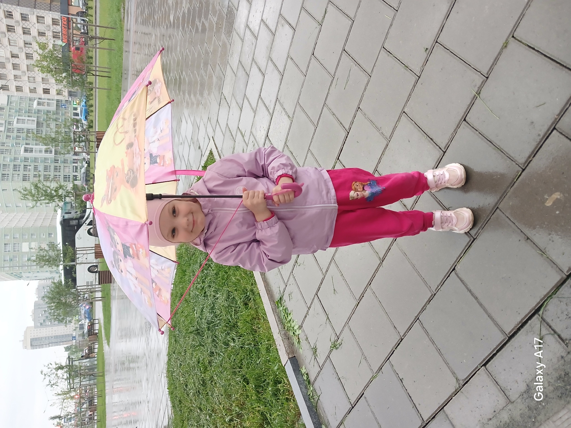 Girl with umbrella spotted on wet Yekaterinburg street