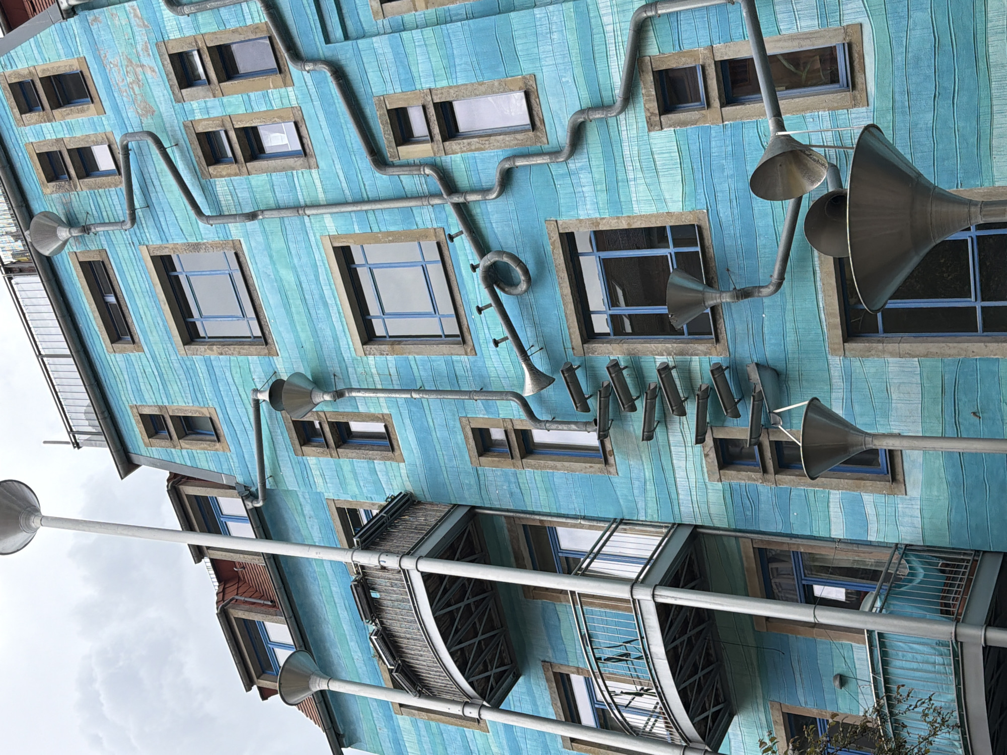 Witnesses document colorful artistic building facades in urban setting