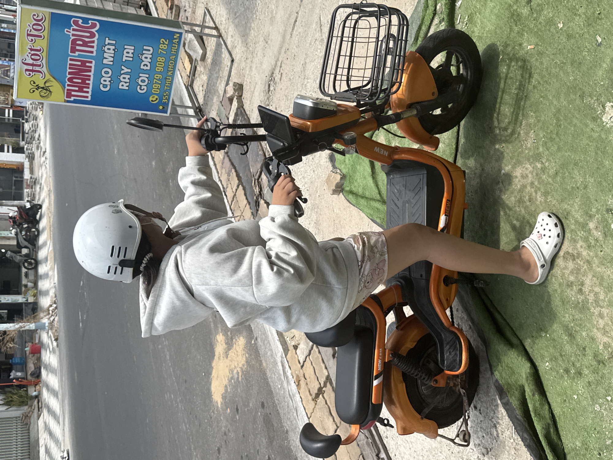 Morning scooter activity on a Phú Thủy street