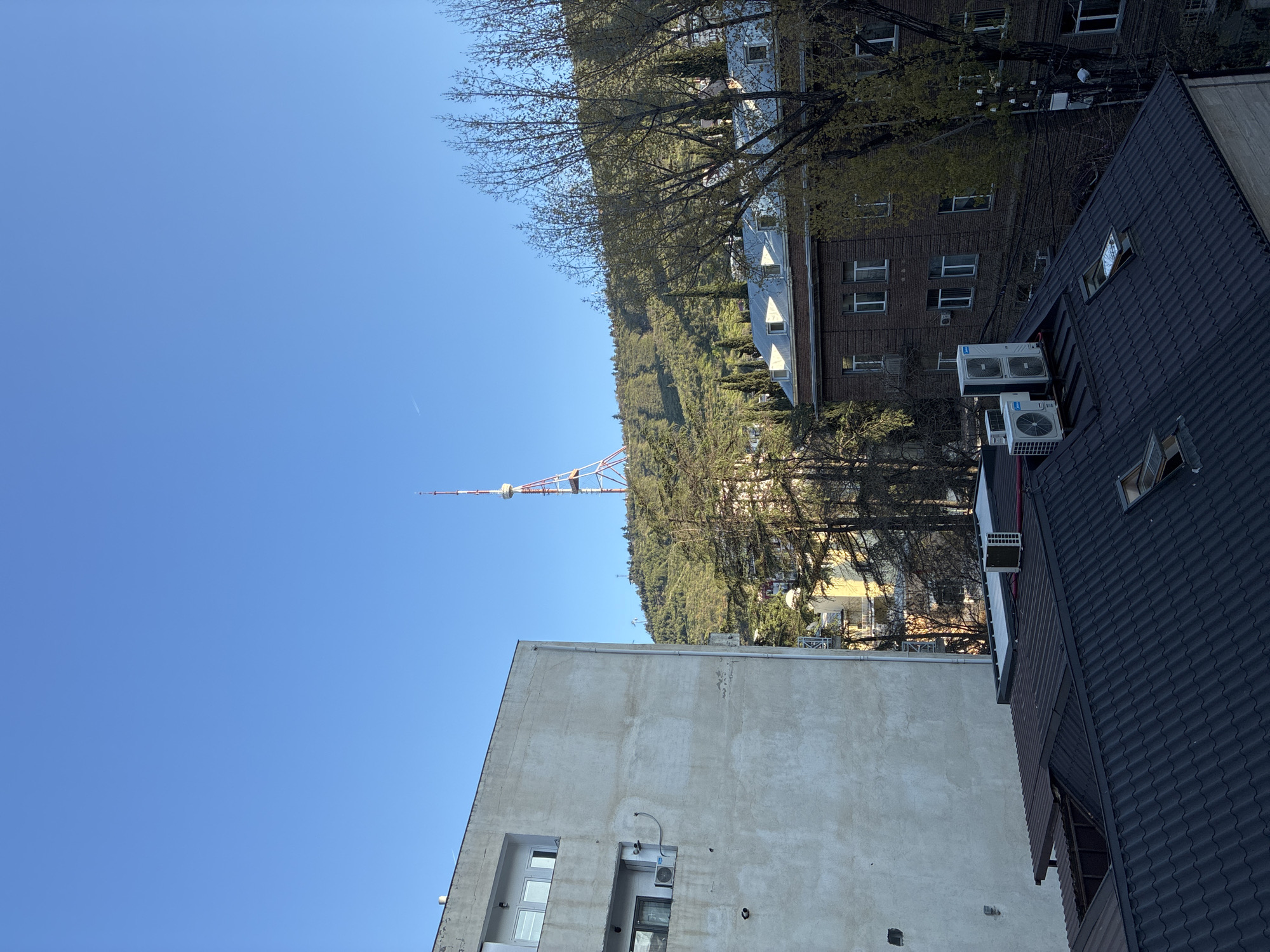 Clear skies frame Tbilisi cityscape with telecommunications tower