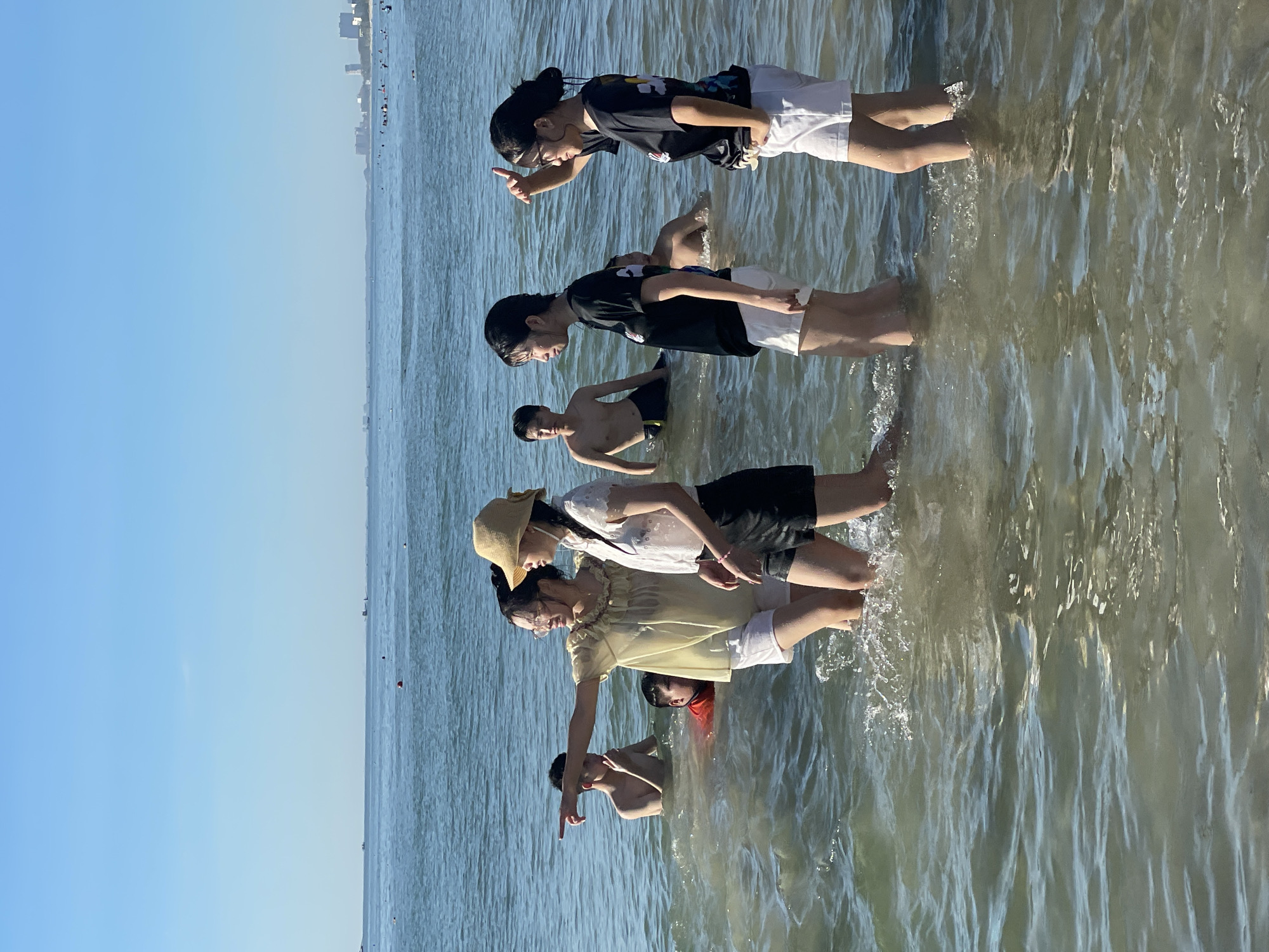 Sunny day at My Khe Beach, Đà Nẵng — wading and relaxing in calm surf.
