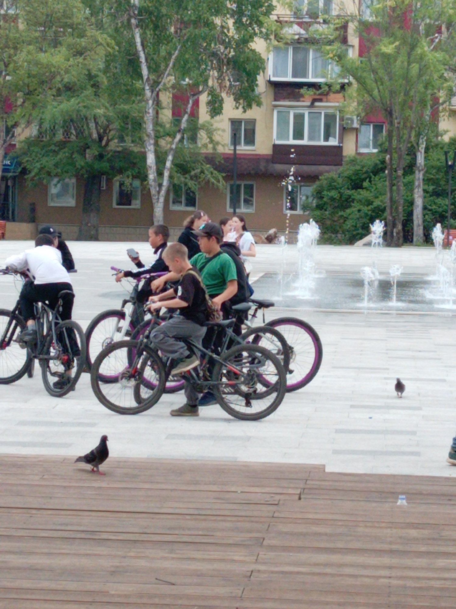 Young cyclists gather at fountain in Artyom square