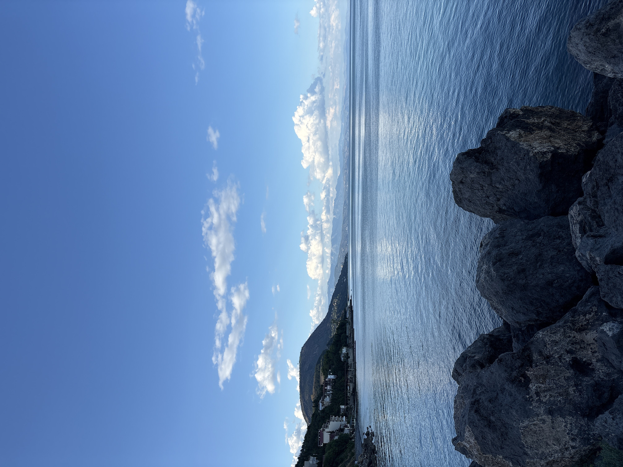 Rocky Crimean shoreline under a clear summer sky