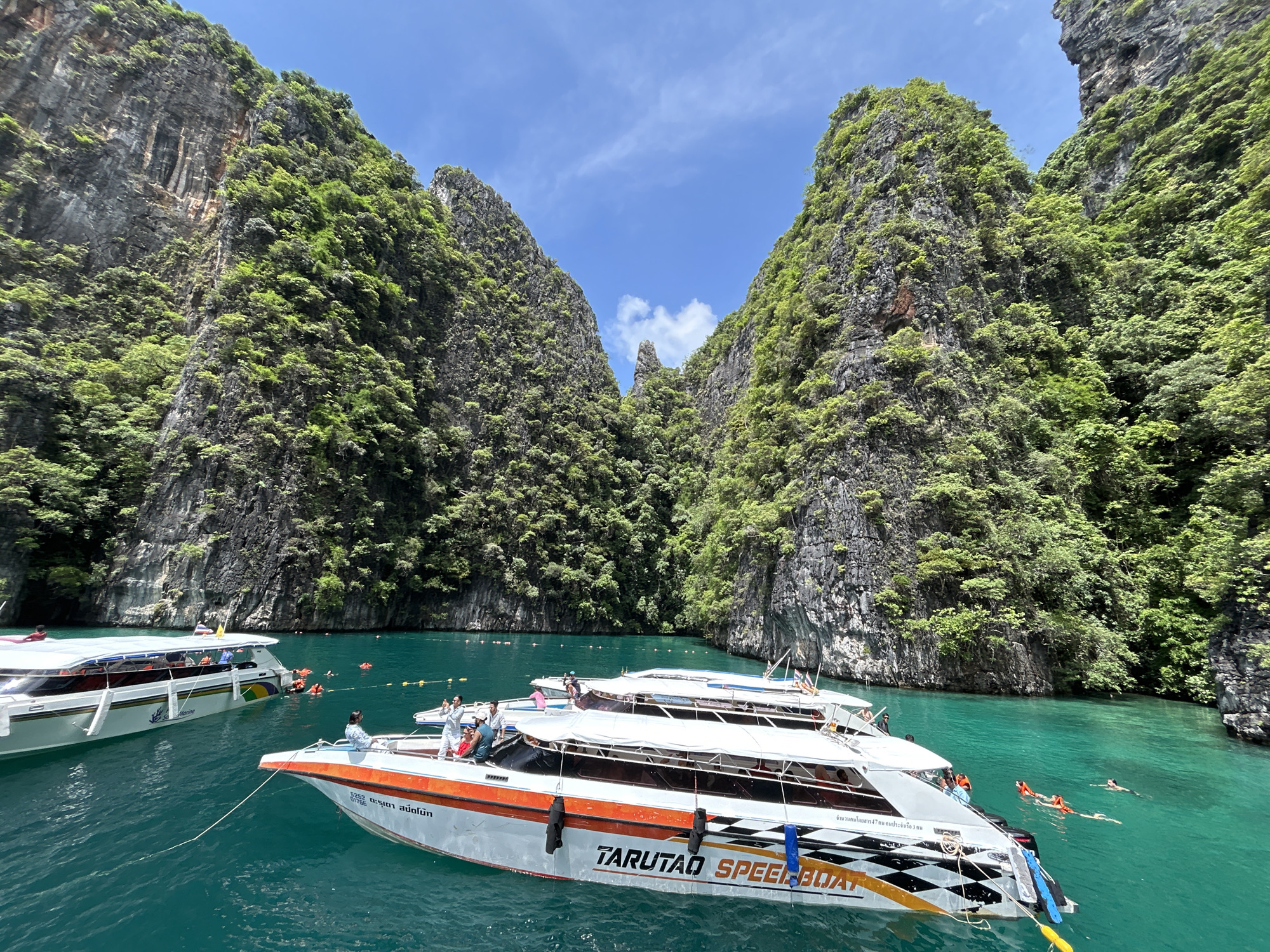 Busy boat bay beneath limestone cliffs, Ao Nang
