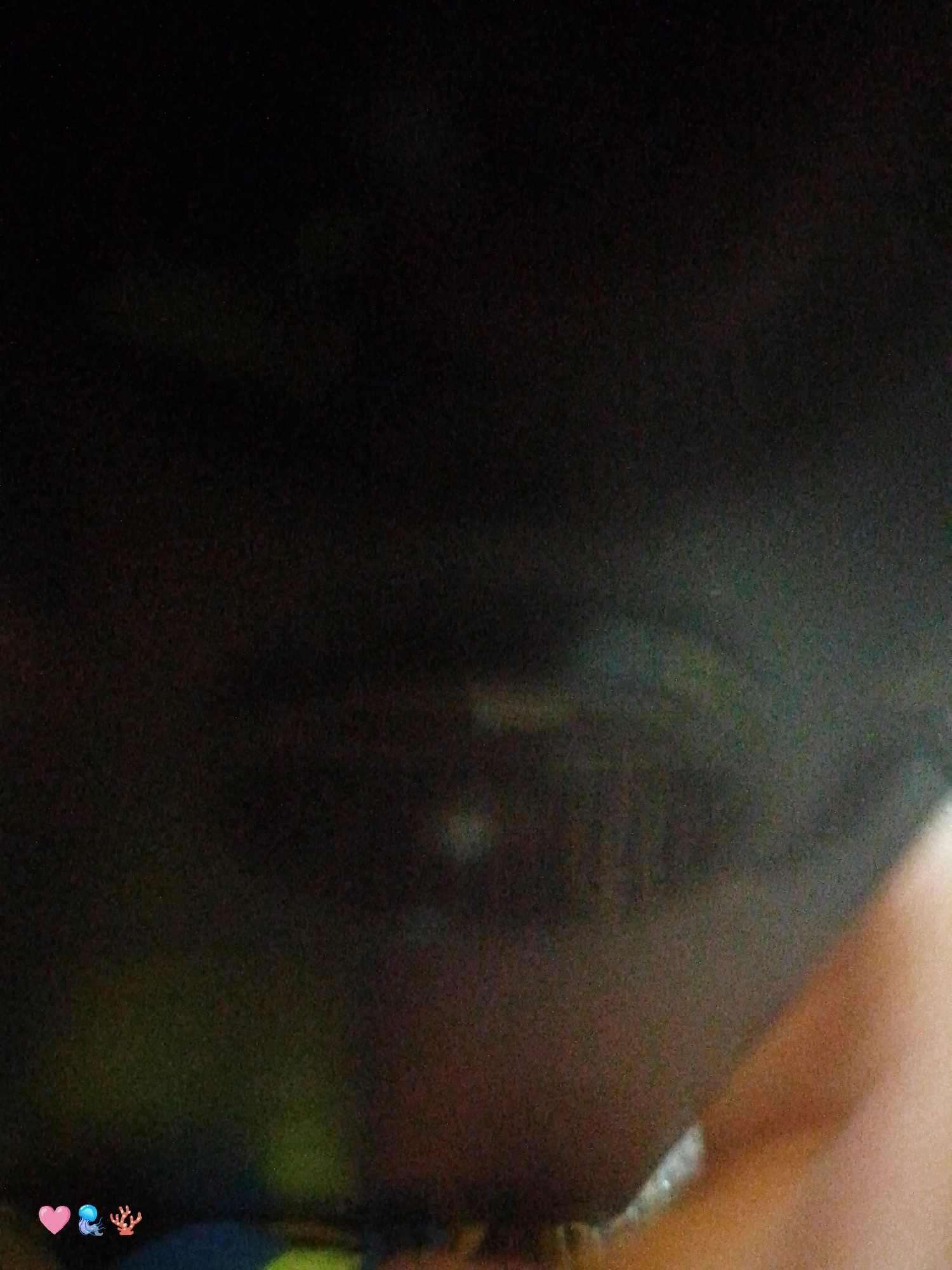 Woman takes selfie, blurry hand photo captured simultaneously indoors