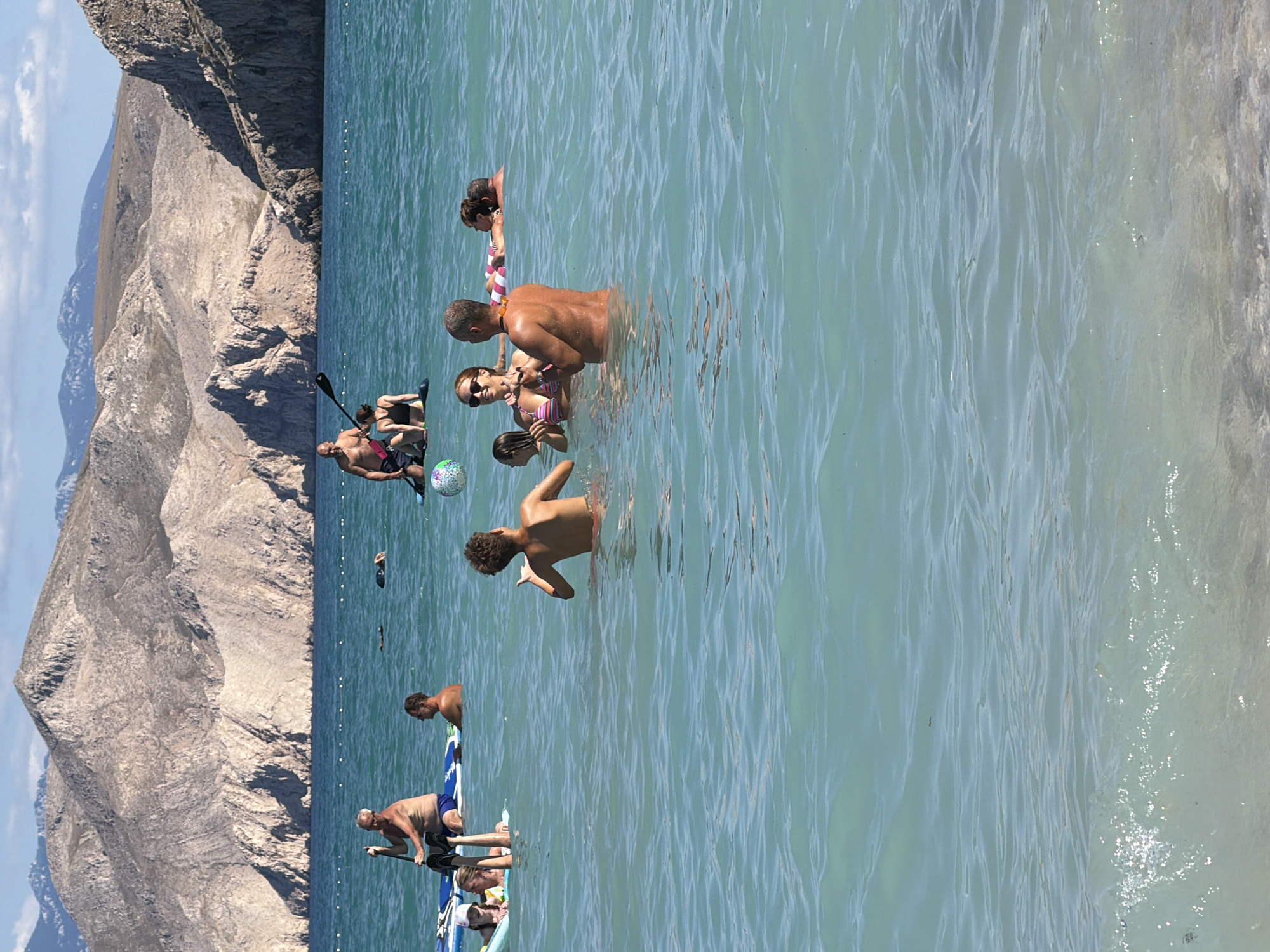 Busy summer day on the pebble beaches of Baška, Croatia