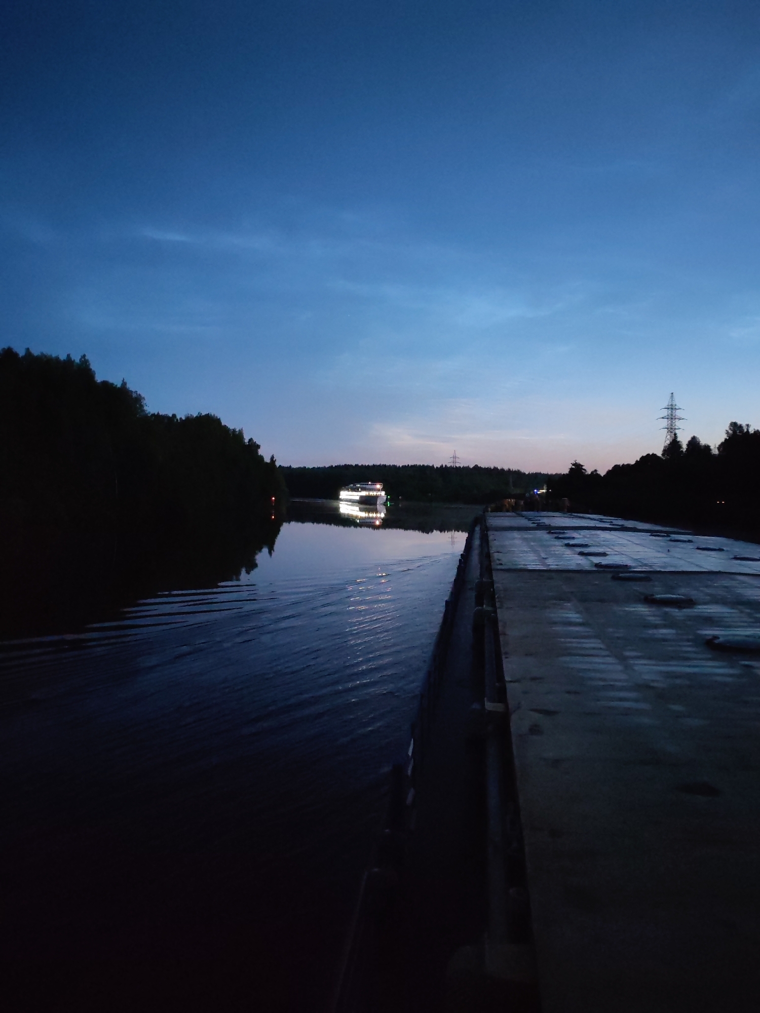 Passenger ship Sergei Artemiev cruises a Russian river at dusk