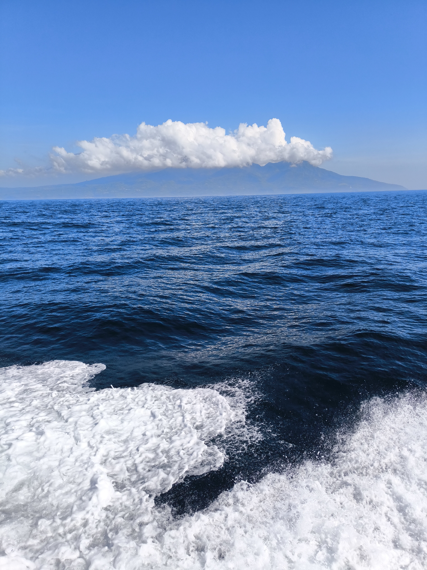Ocean waves and mountain landscape observed in Indonesia