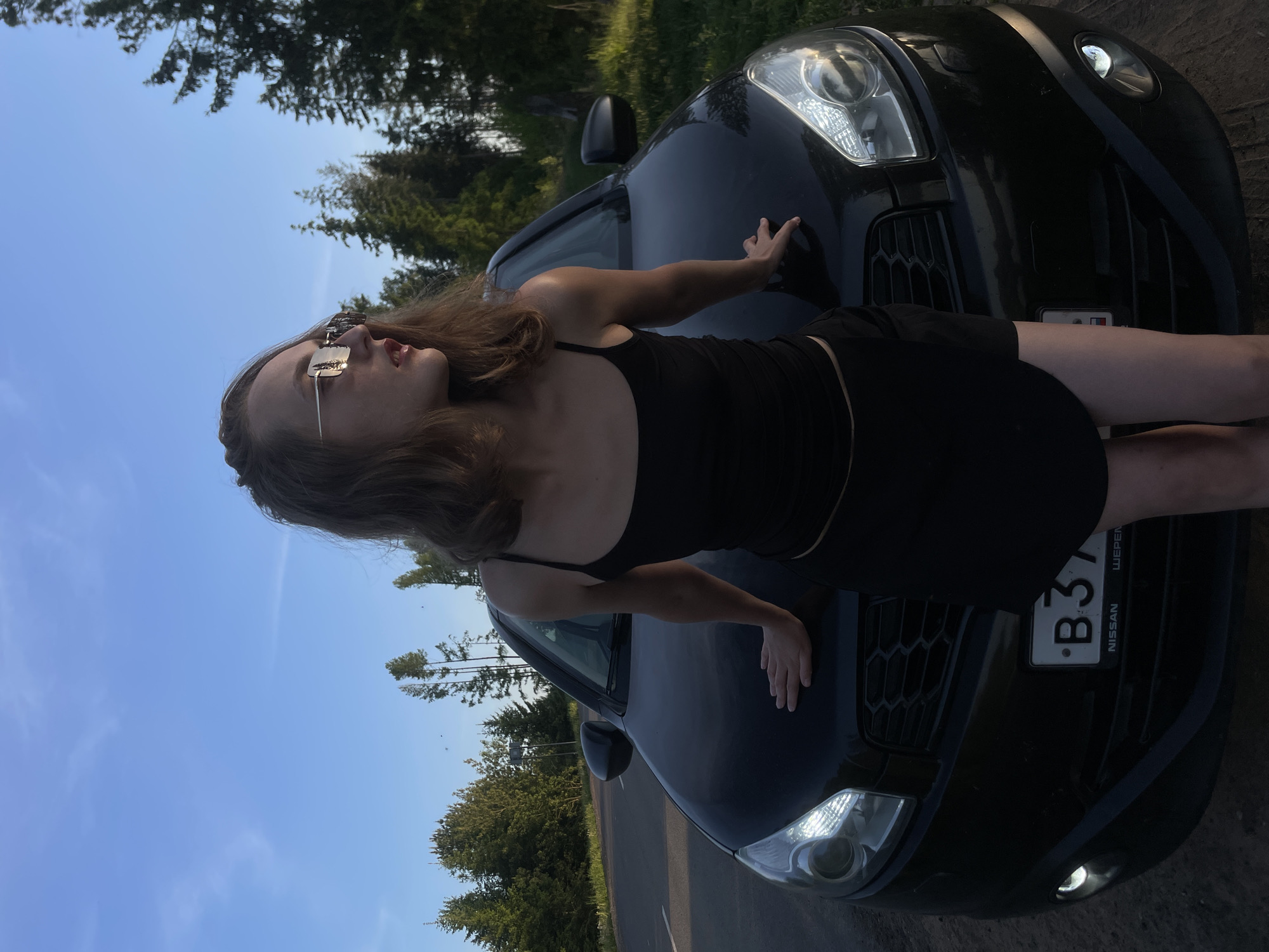 Woman poses with Nissan sedan in Russian countryside photoshoot
