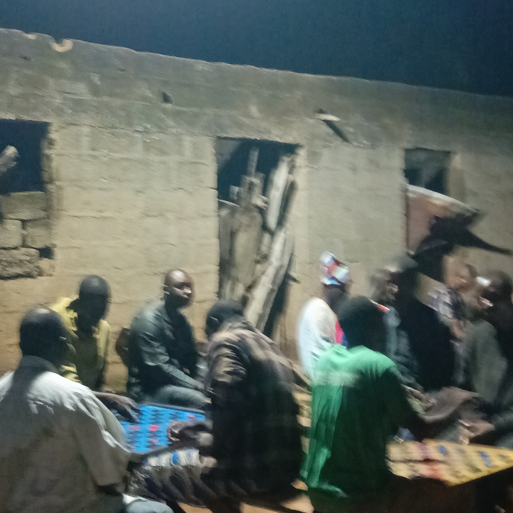 Men gather for nighttime board game in Akwanga, Nigeria