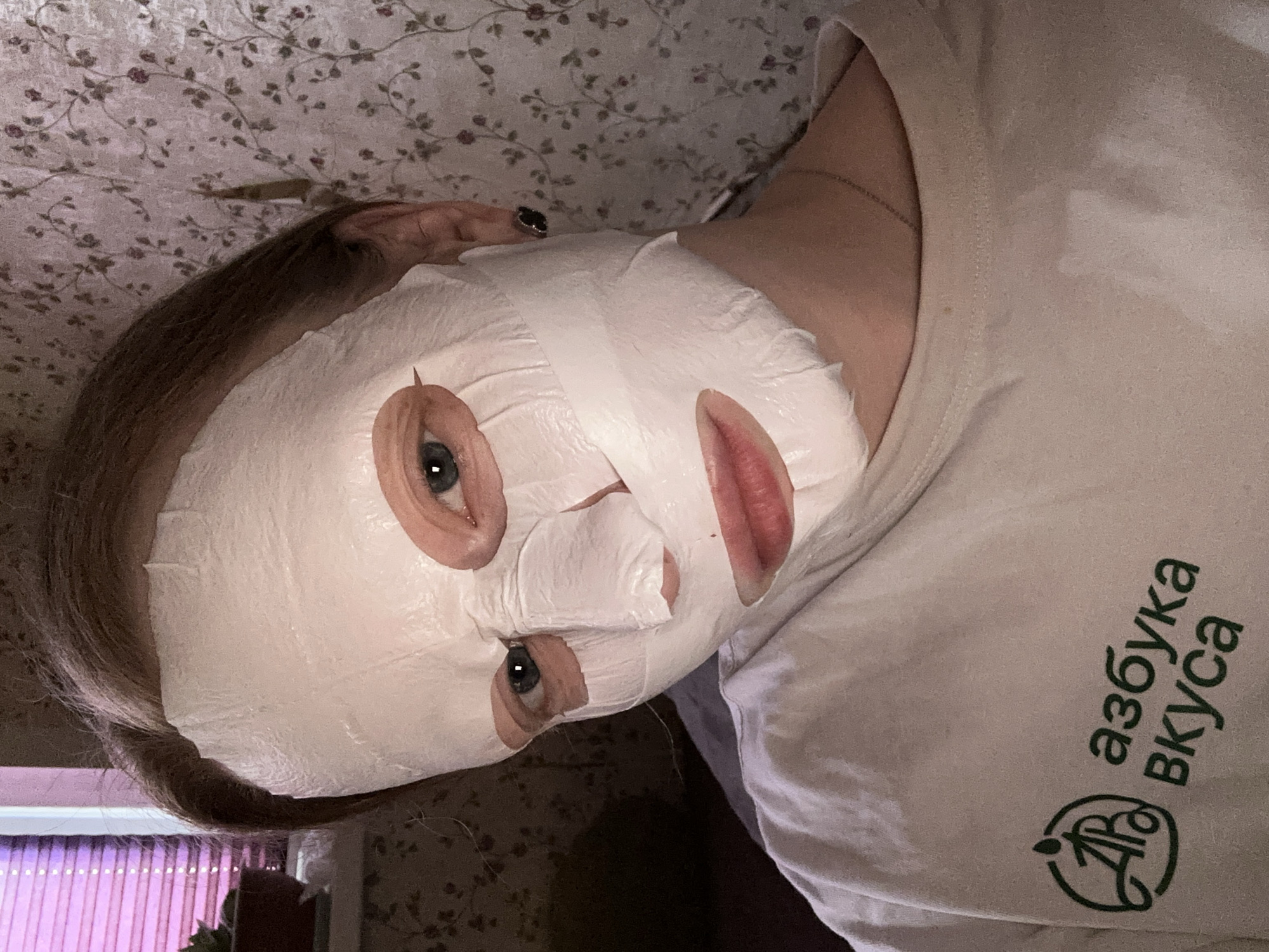 Moscow resident uses facial mask while wearing grocery store shirt