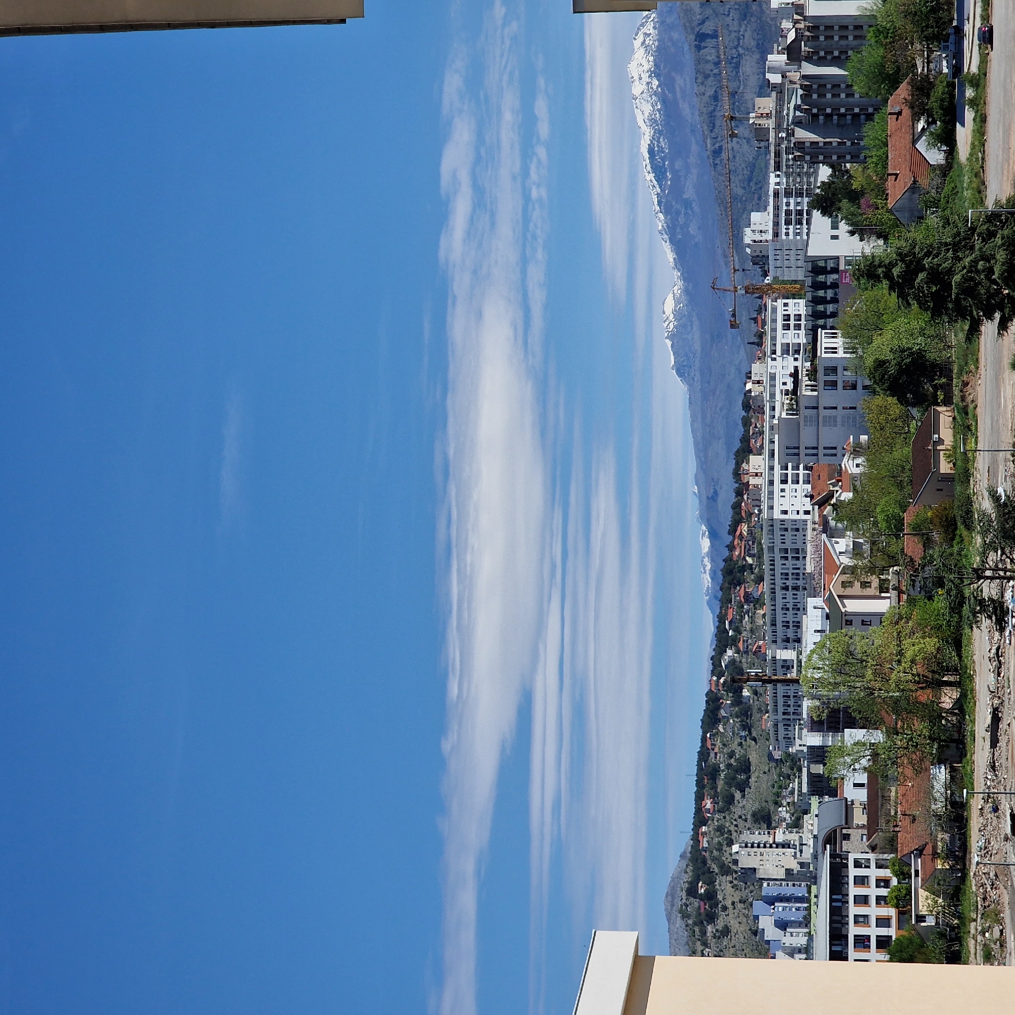 Podgorica cityscape documented against mountainous backdrop with cloudy skies