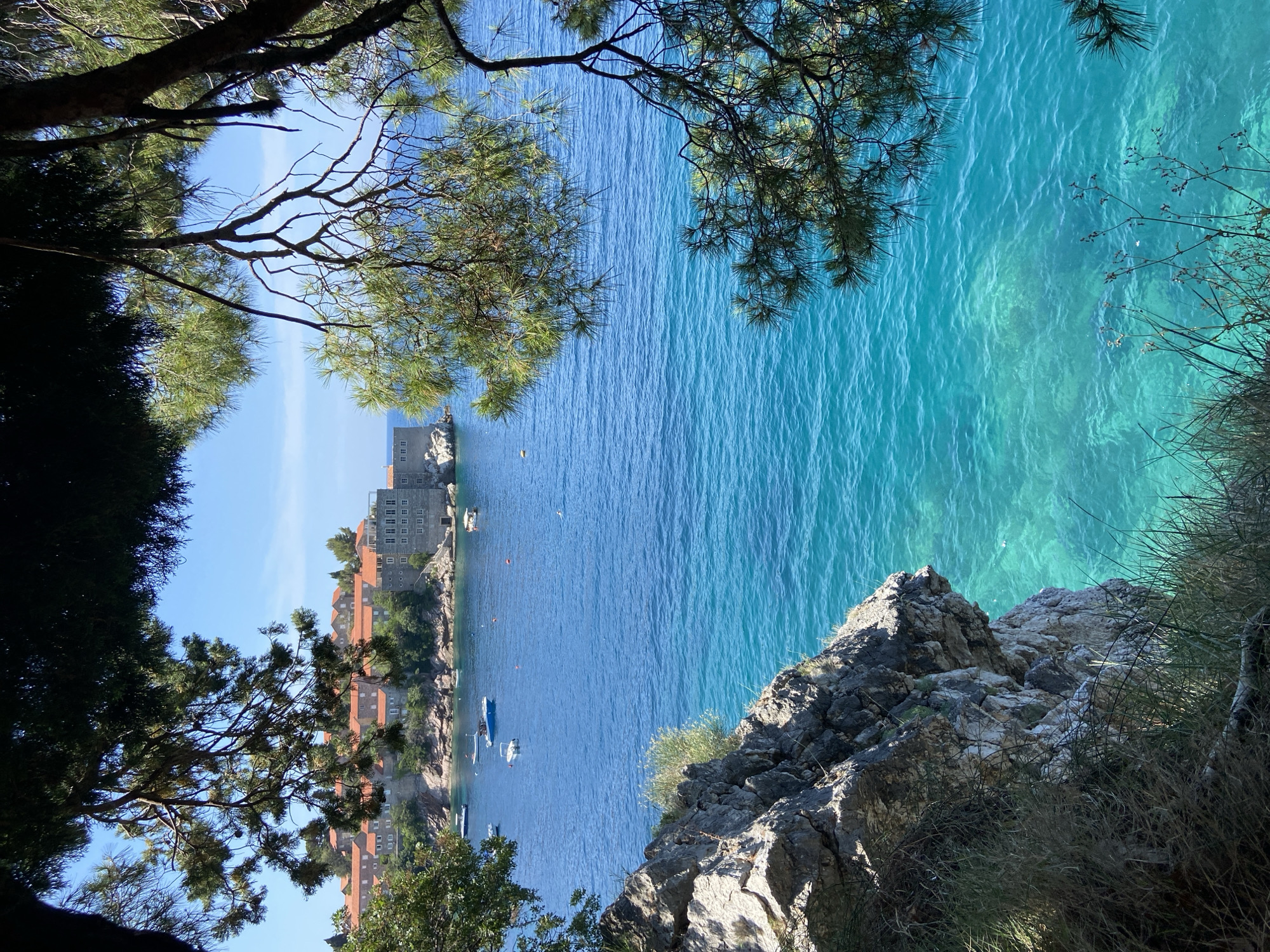 Tourist documents scenic views of Montenegro's Sveti Stefan resort island