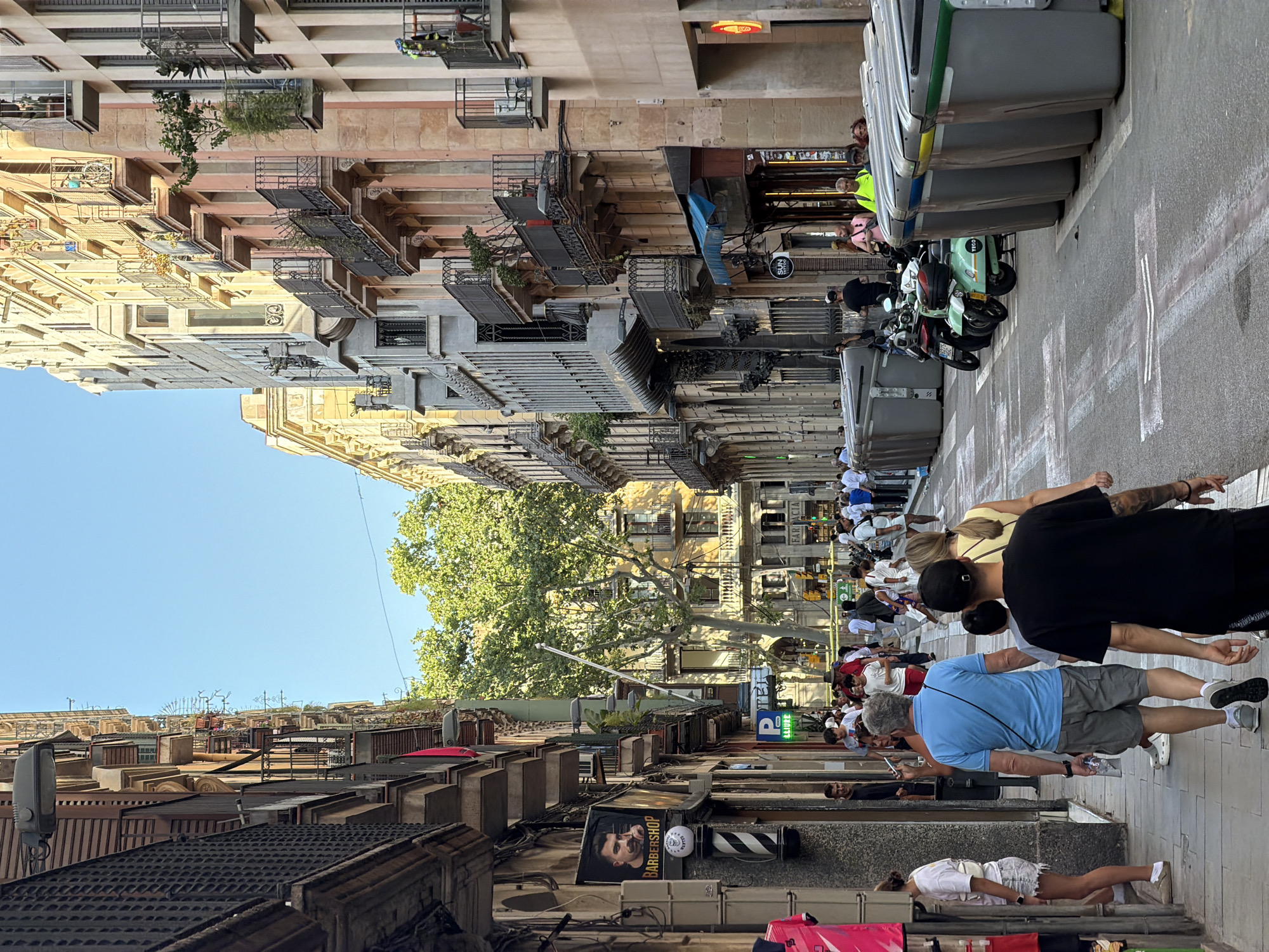 Barcelona streets and plazas on a busy sunny afternoon