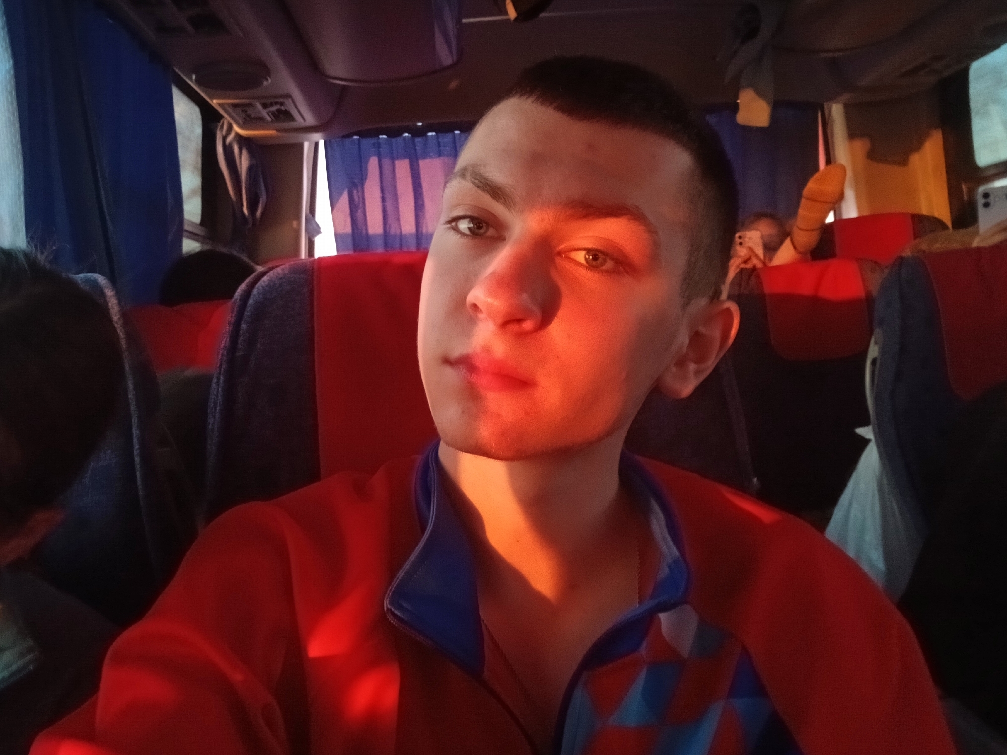 Young man in red jacket observed on bus in Svetlyi