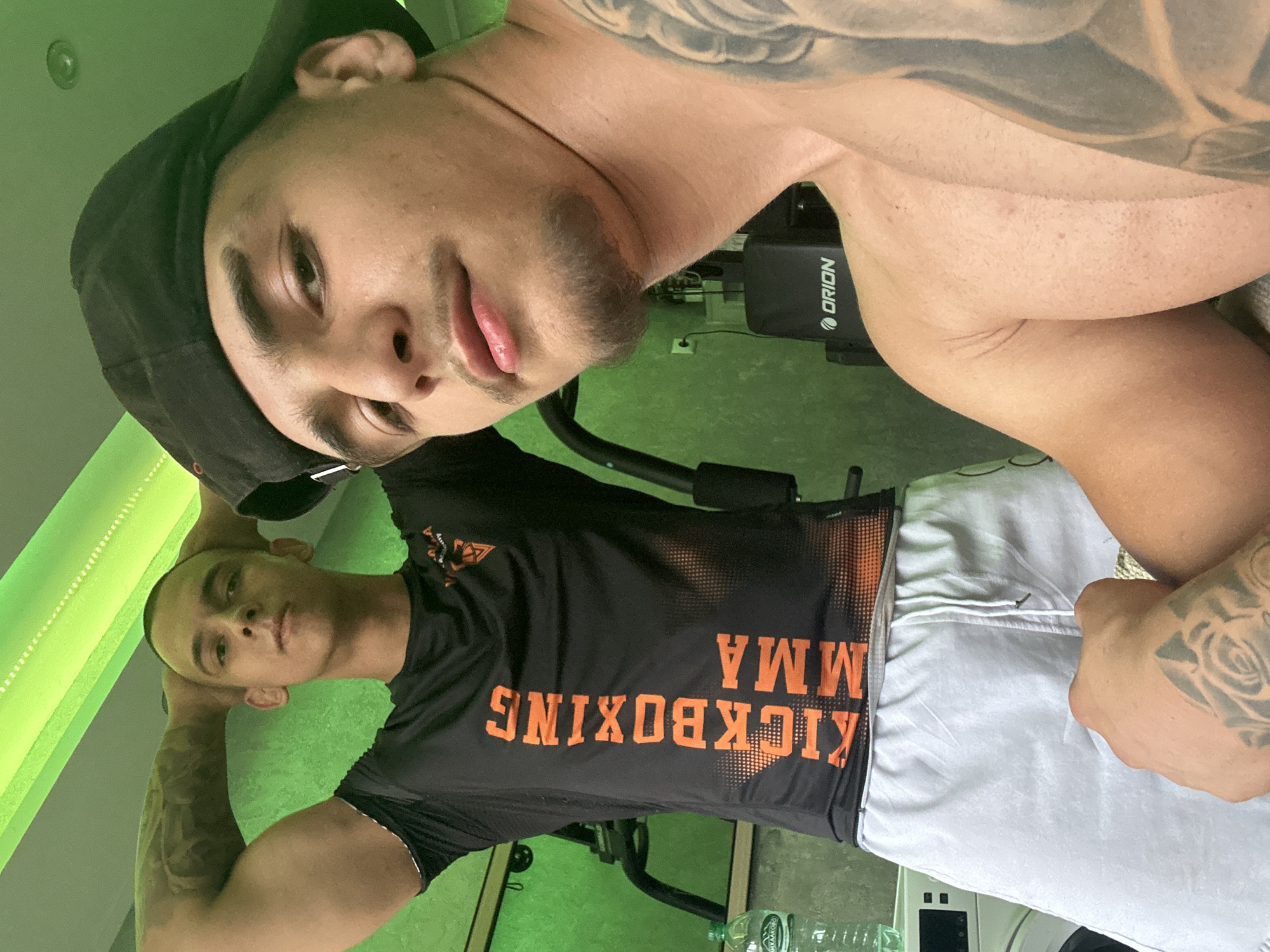 Two men documented during gym workout session with weights