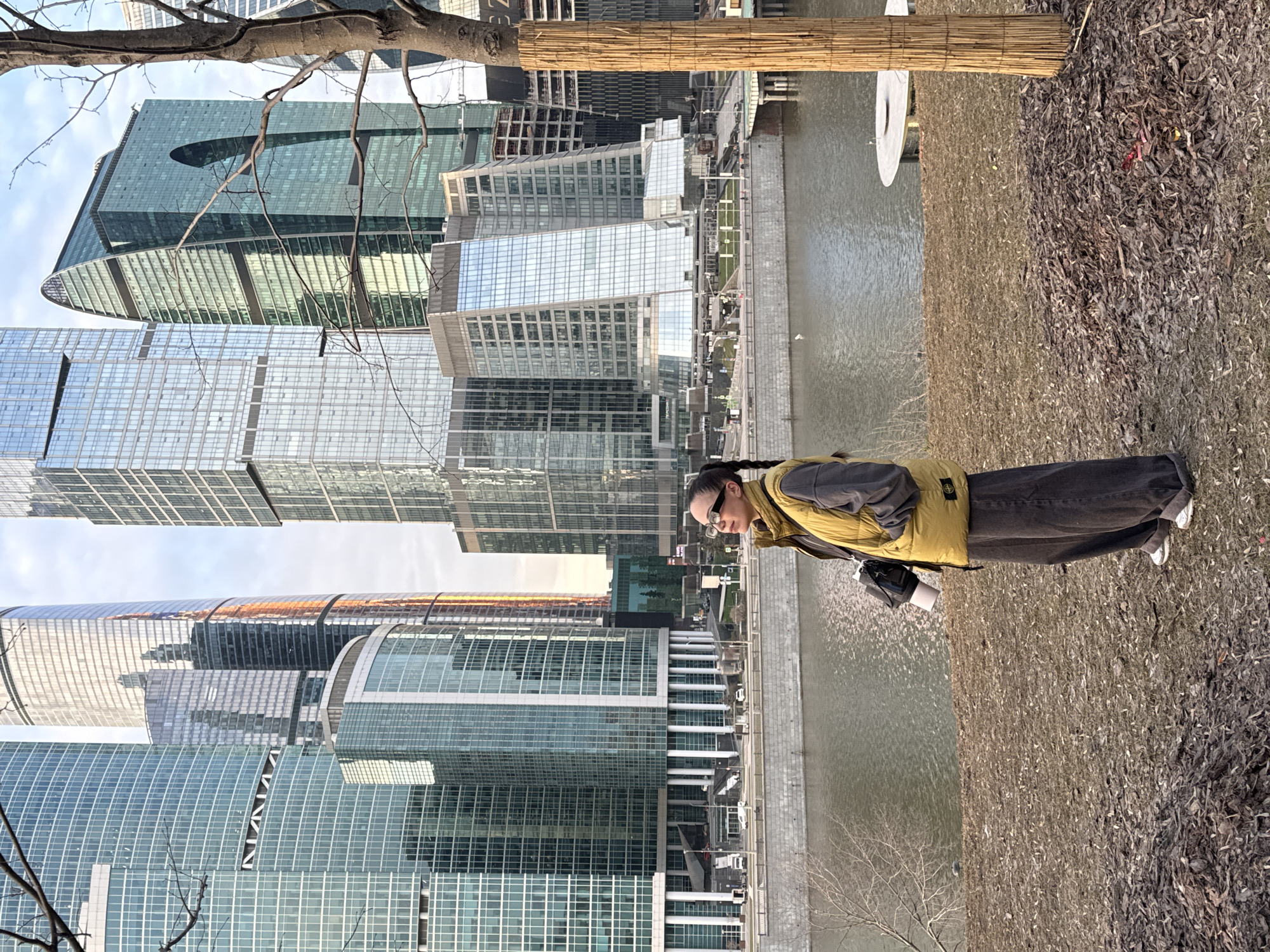 Woman stands by Moskva River viewing Moscow-City skyline