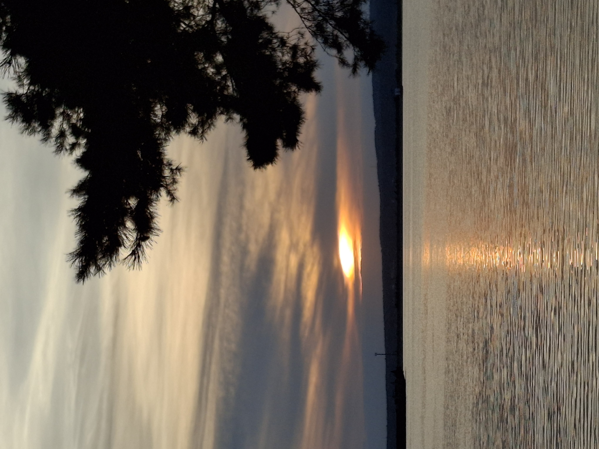 Sunset on the Kama River, Chaikovsky, with a speedboat passing through.