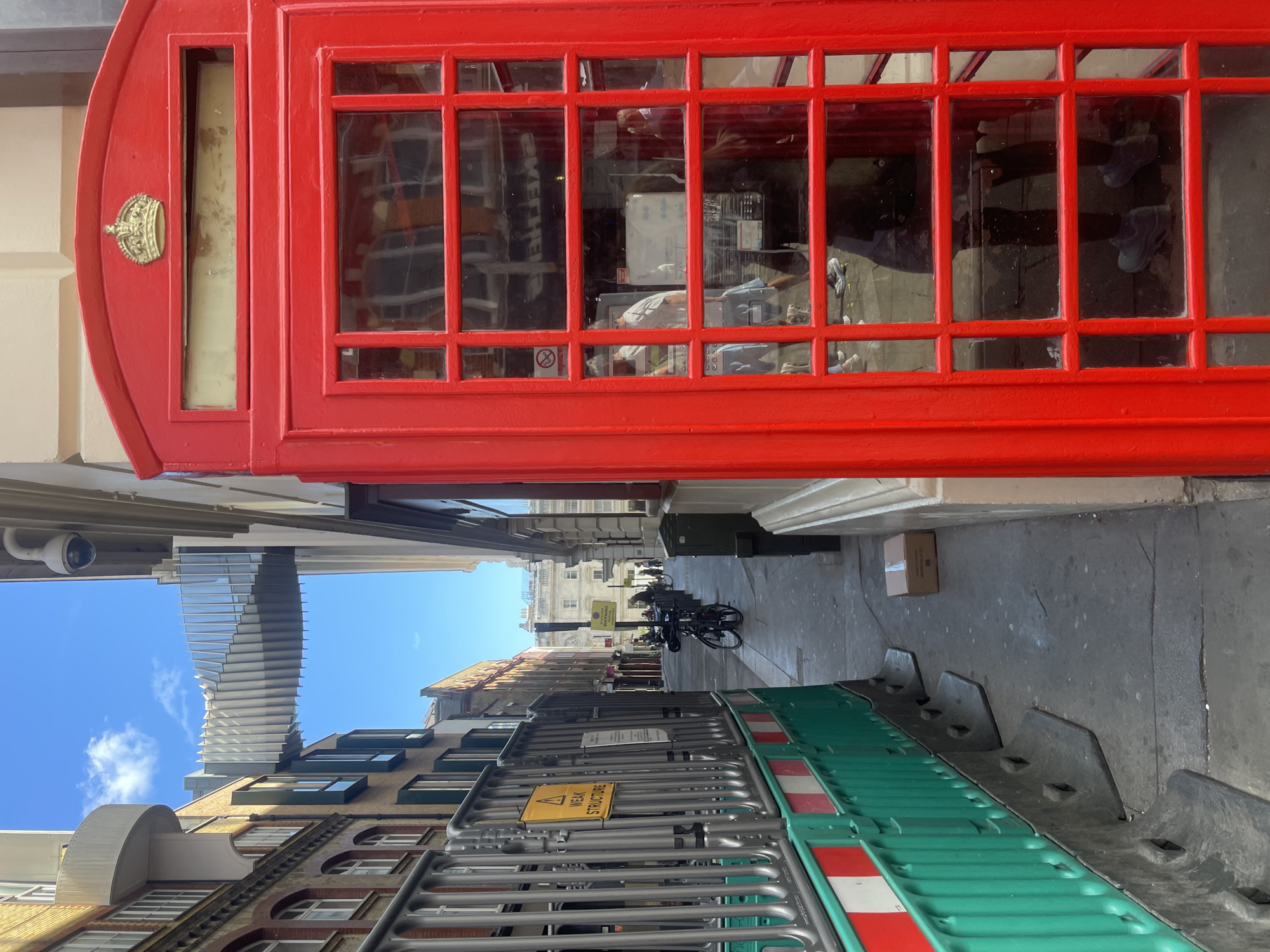 Sunny morning around a red phone box in Covent Garden