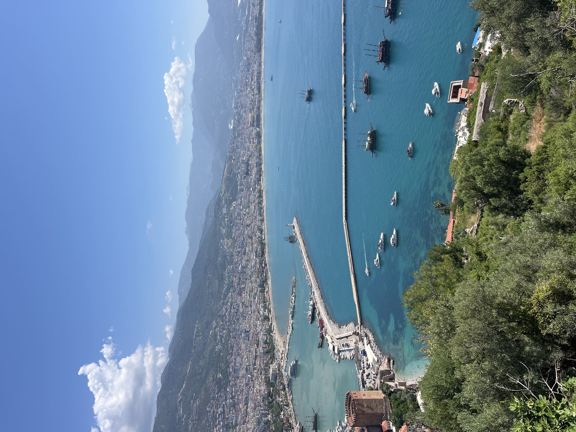 Aerial views capture Alanya Turkey coastline and harbor activity