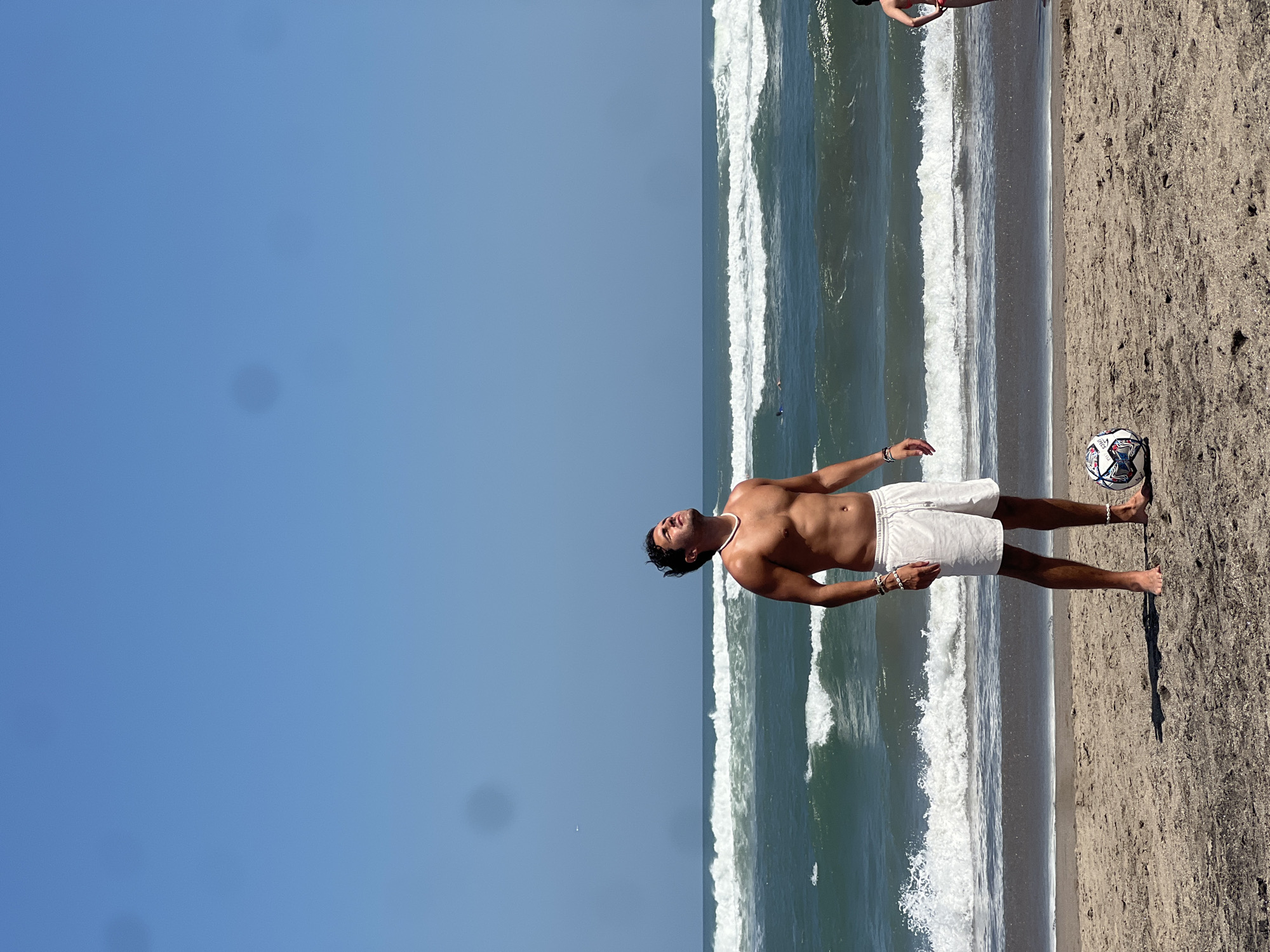 Surfboard and shoreline at a North Kuta beach warung