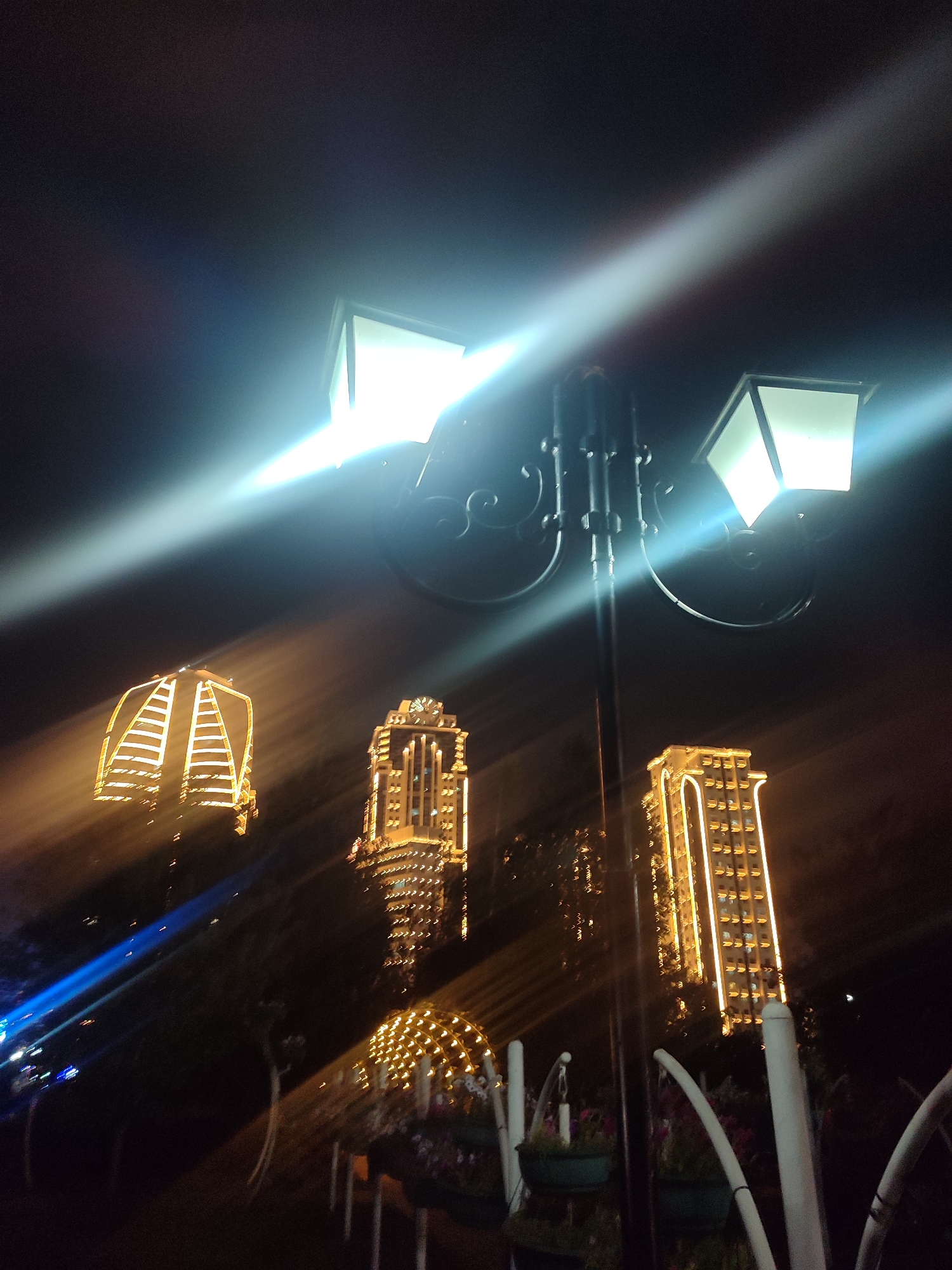 Grozny park at night: lit fountains, glowing archways, and walkways