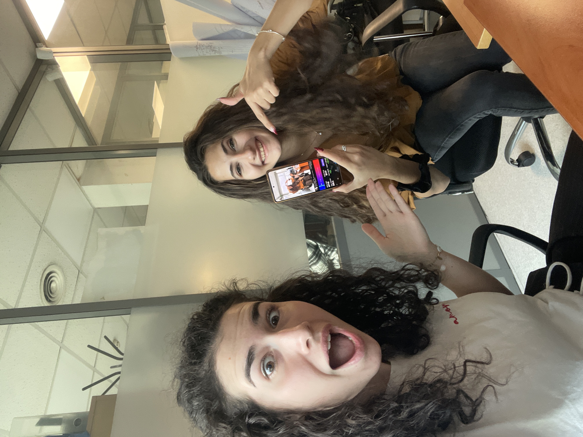 Two women pose for photos in Sofia office