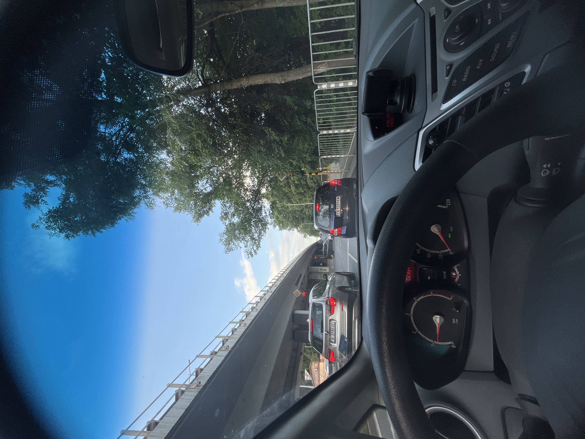 Driver documents sunny day traffic conditions from vehicle