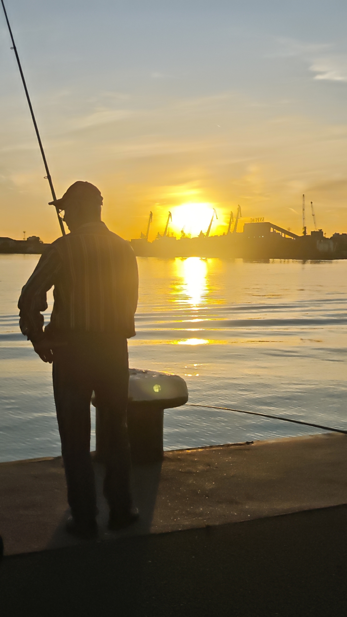 Evening fishing scene captured at Burgas harbor during sunset