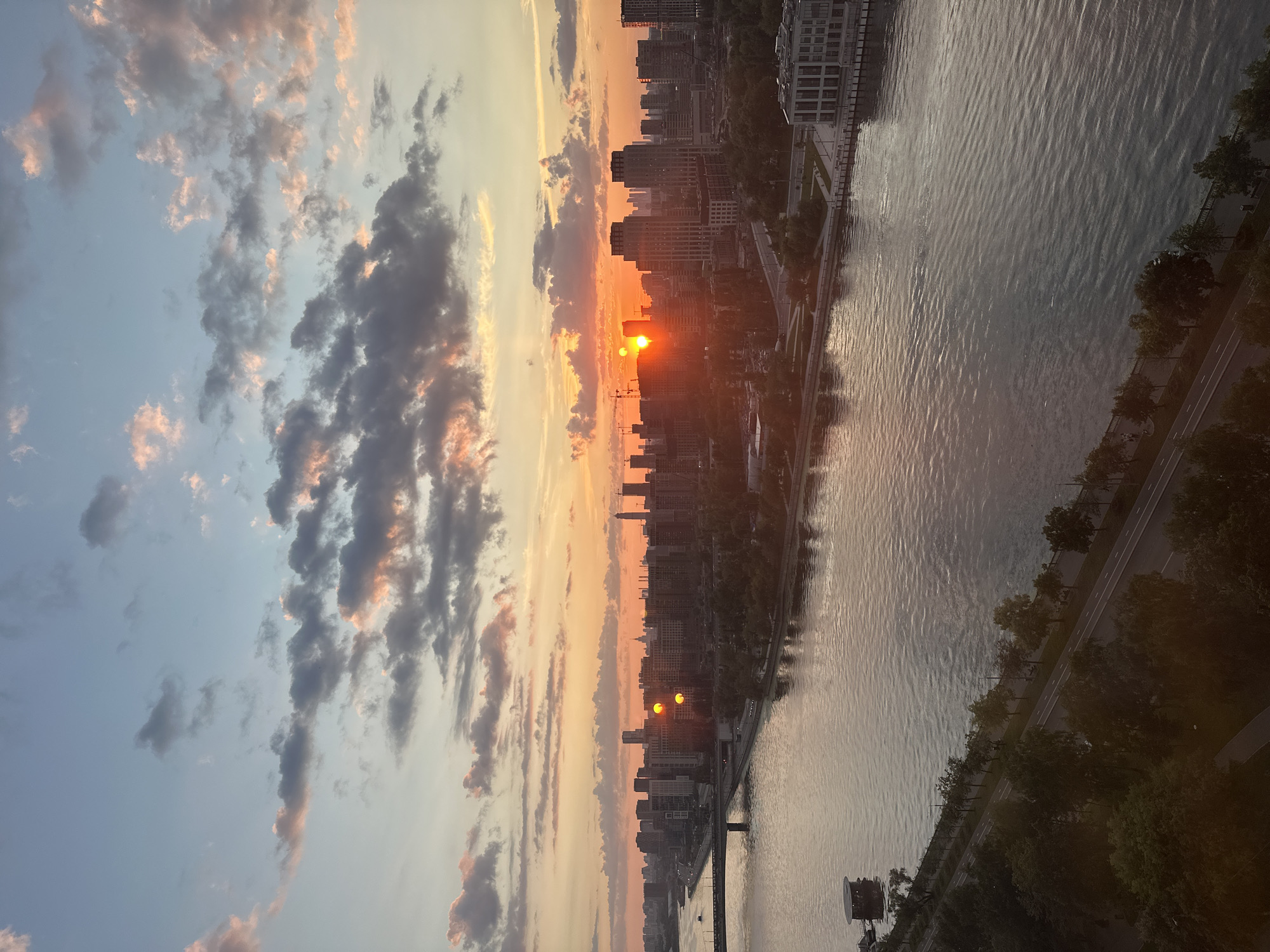 Moscow River at golden hour, city skyline reflecting the sunset